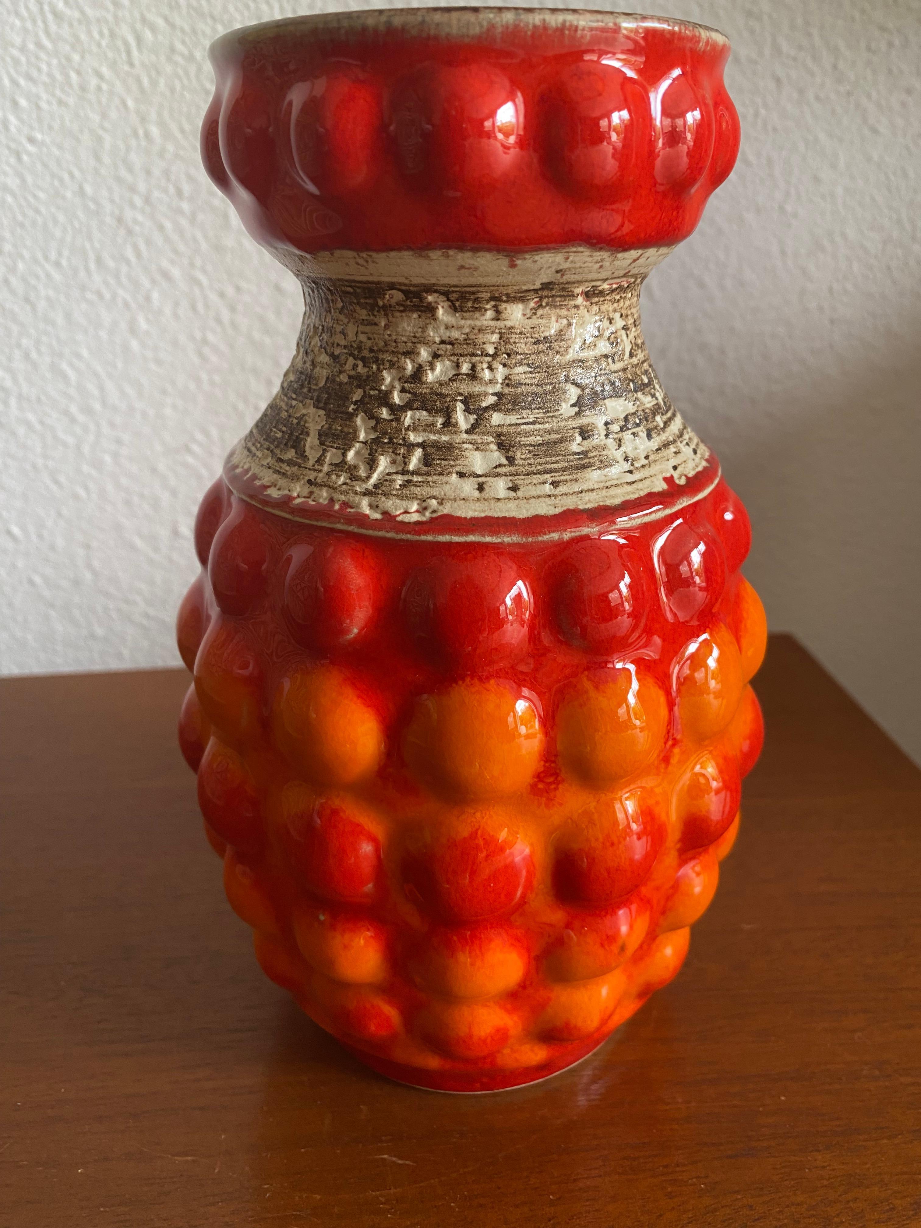 Vibrant Orange Seventies tall Bay vase, quite rare decor and to my opinion the most attractive vase from this period. 
I have a similar (large) one for sale in another color scheme. 
Designer: Bodo Mans was employed by the Bay Keramik company from