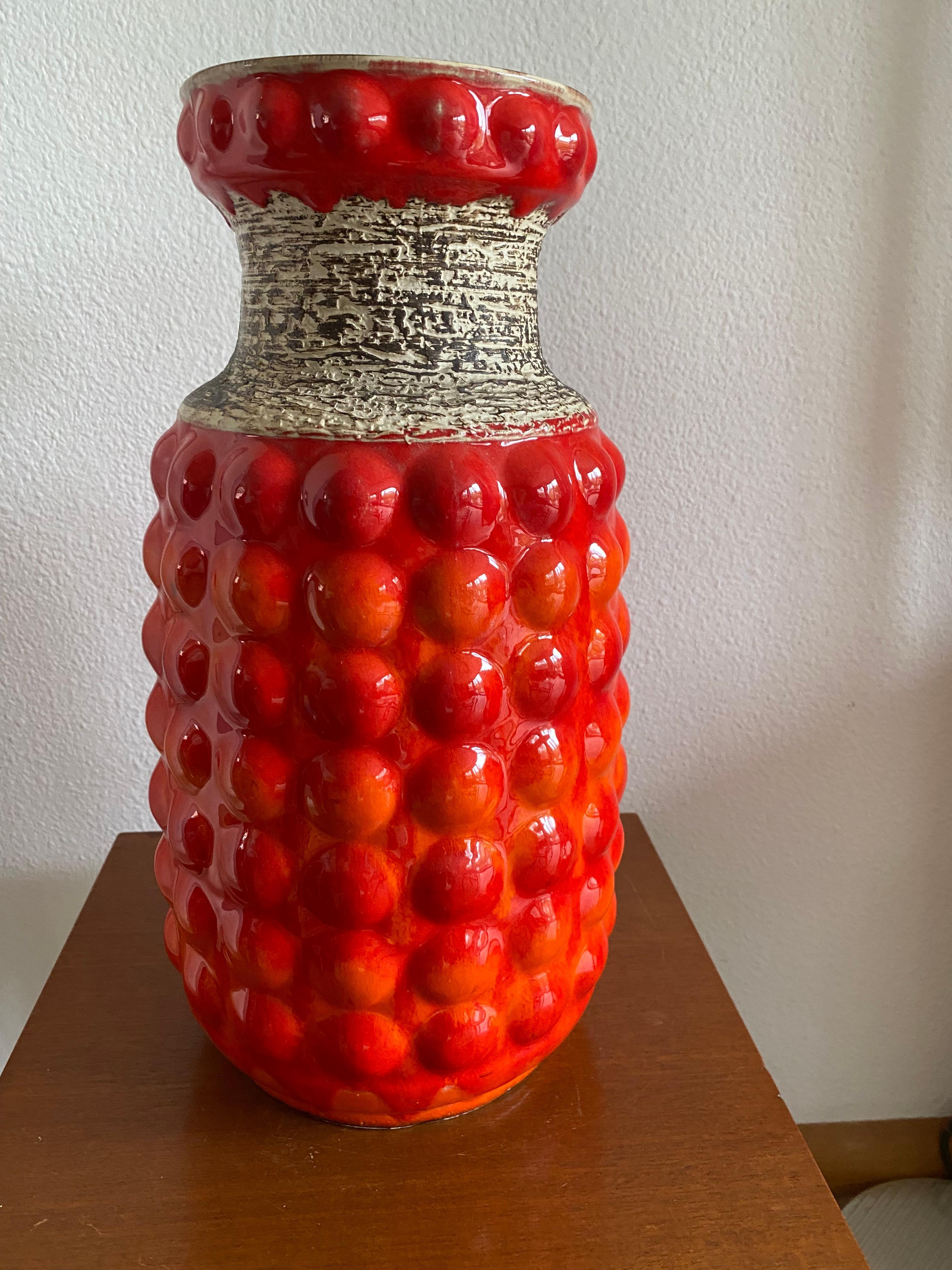 Vibrant Orange Seventies tall Bay vase, quite rare decor and to my opinion the most attractive vase from this period. 
I have a similar one for sale in another color scheme and a smaller one in this vibrant orange.
Designer: Bodo Mans was employed