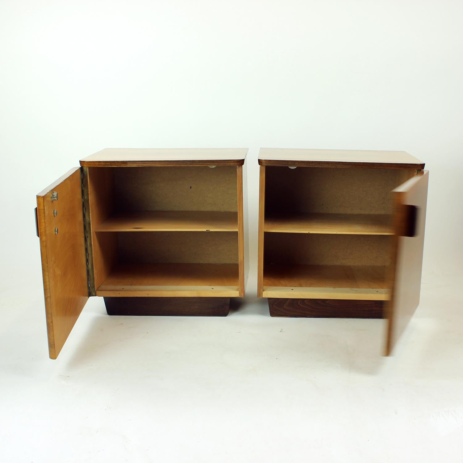 Beautiful set of two bedside tables from Midcentury period of Czechoslovakian design. Produced in 1960s, the tables show an elegant design with beautiful details. The tables are square in design with one single doog on piano hindges. There is a