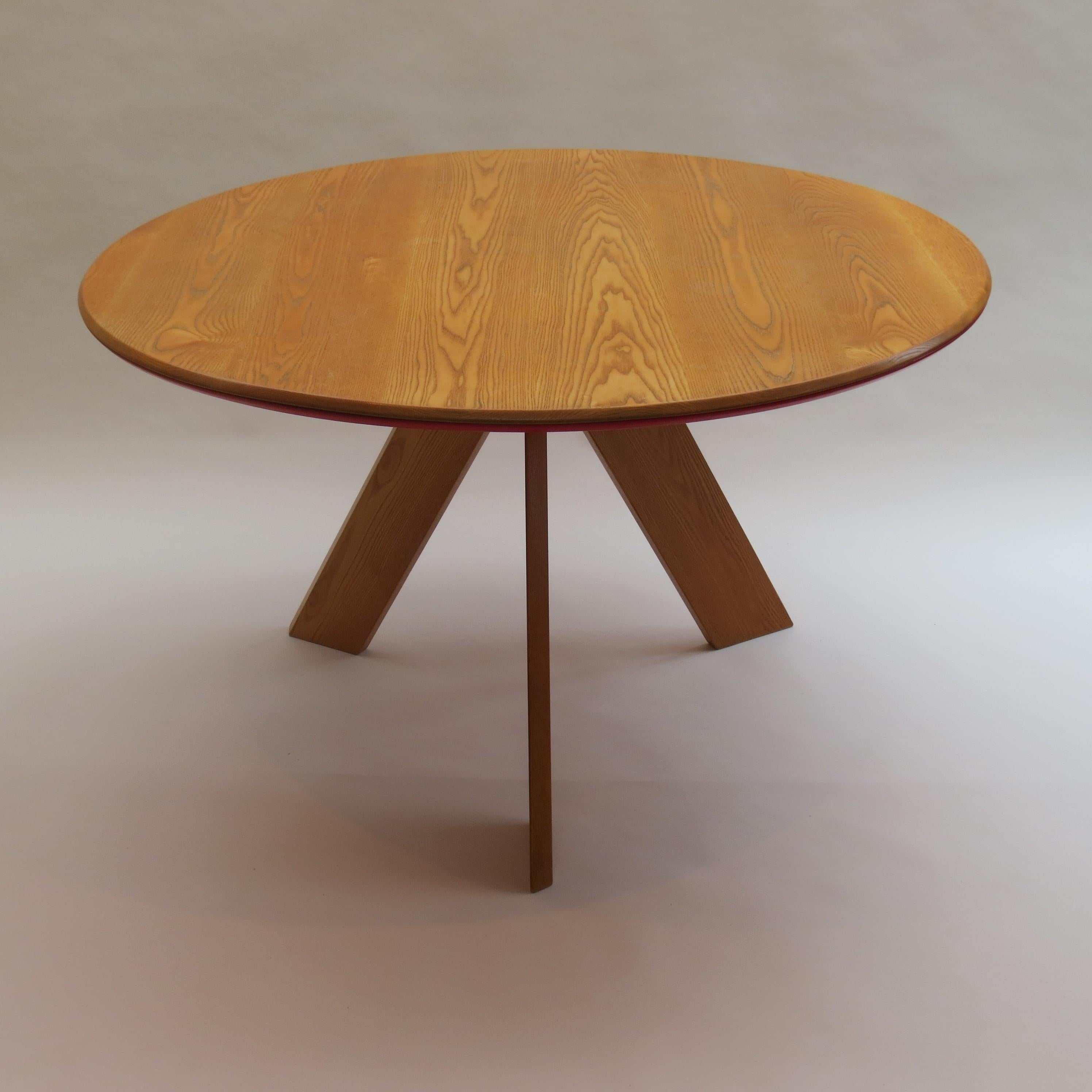 A very nicely detailed and good quality round dining table designed and produced by David Field. Bespoke made in solid ash base with blue aluminium Bose on the underside. The solid ash circular top has a painted red MDF to the underside.

A very