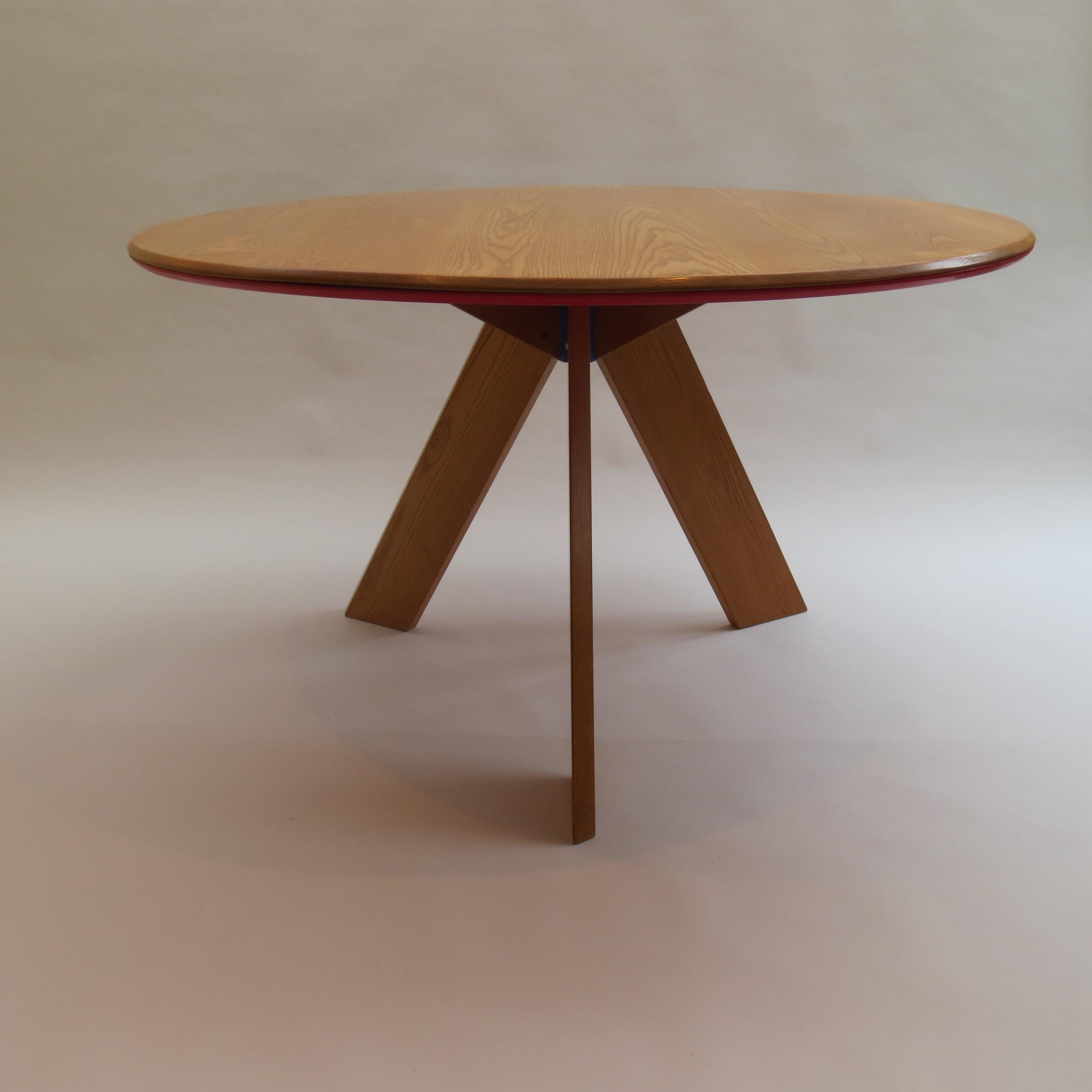 A very nicely detailed and good quality round dining table designed and produced by David Field. Bespoke made in solid ash base with blue aluminium Bose on the underside. The solid ash circular top has a painted red MDF to the underside.

A very