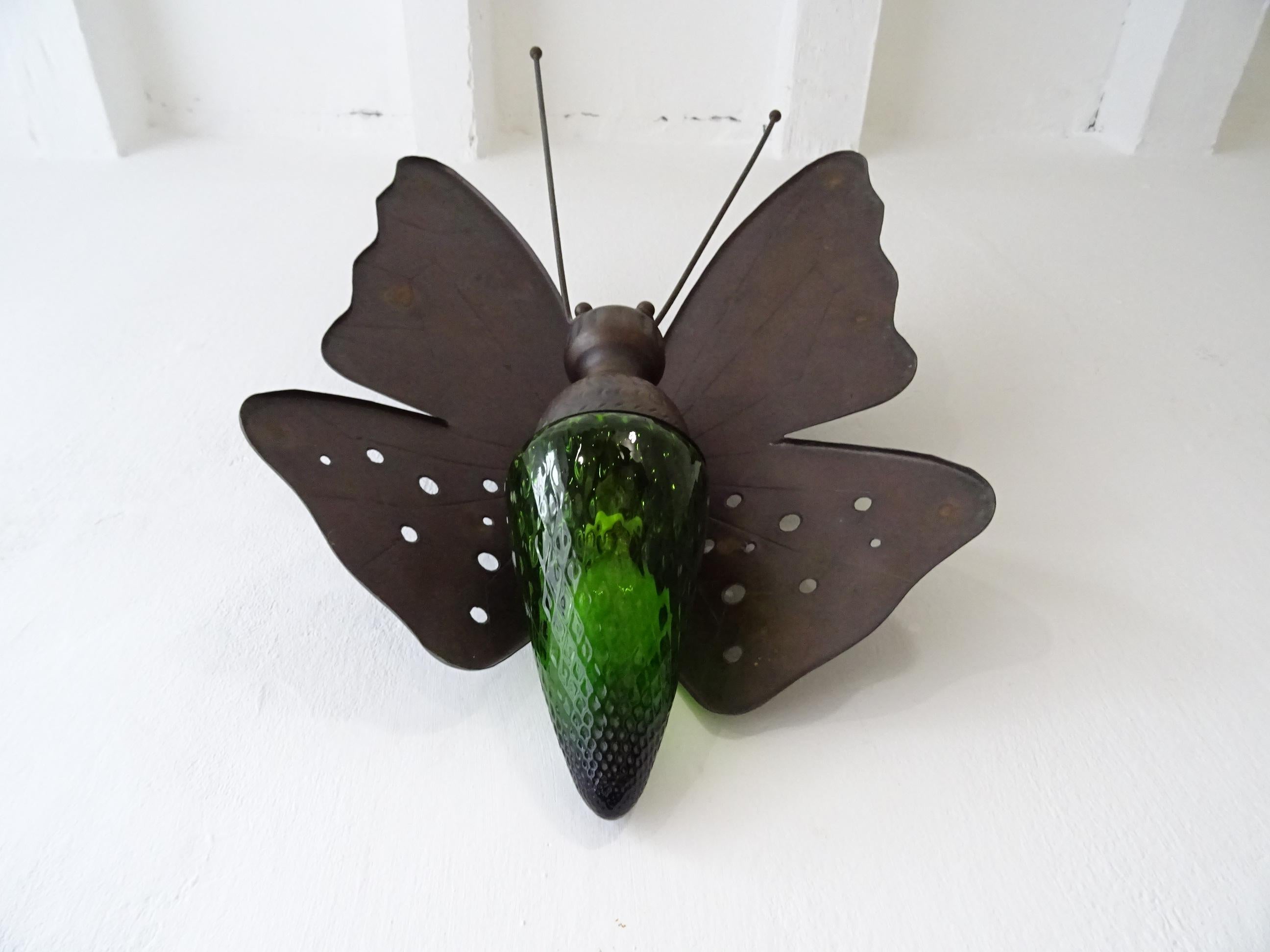 Extremely rare Murano butterfly sconce. Housing one light. Will be rewired with certified UL US sockets for the USA and an appropriate socket for all other countries and ready to hang. Wrought iron body with detailed rare green Murano glass body.