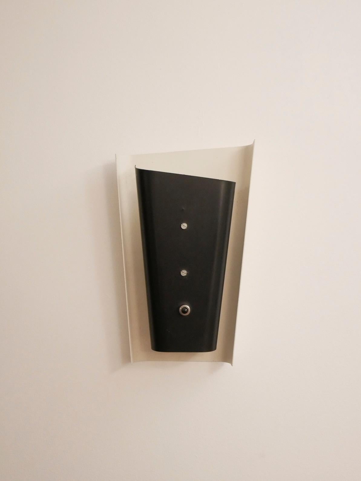 Midcentury French wall sconce in the manner of Jacques Biny, black and white painted metal.