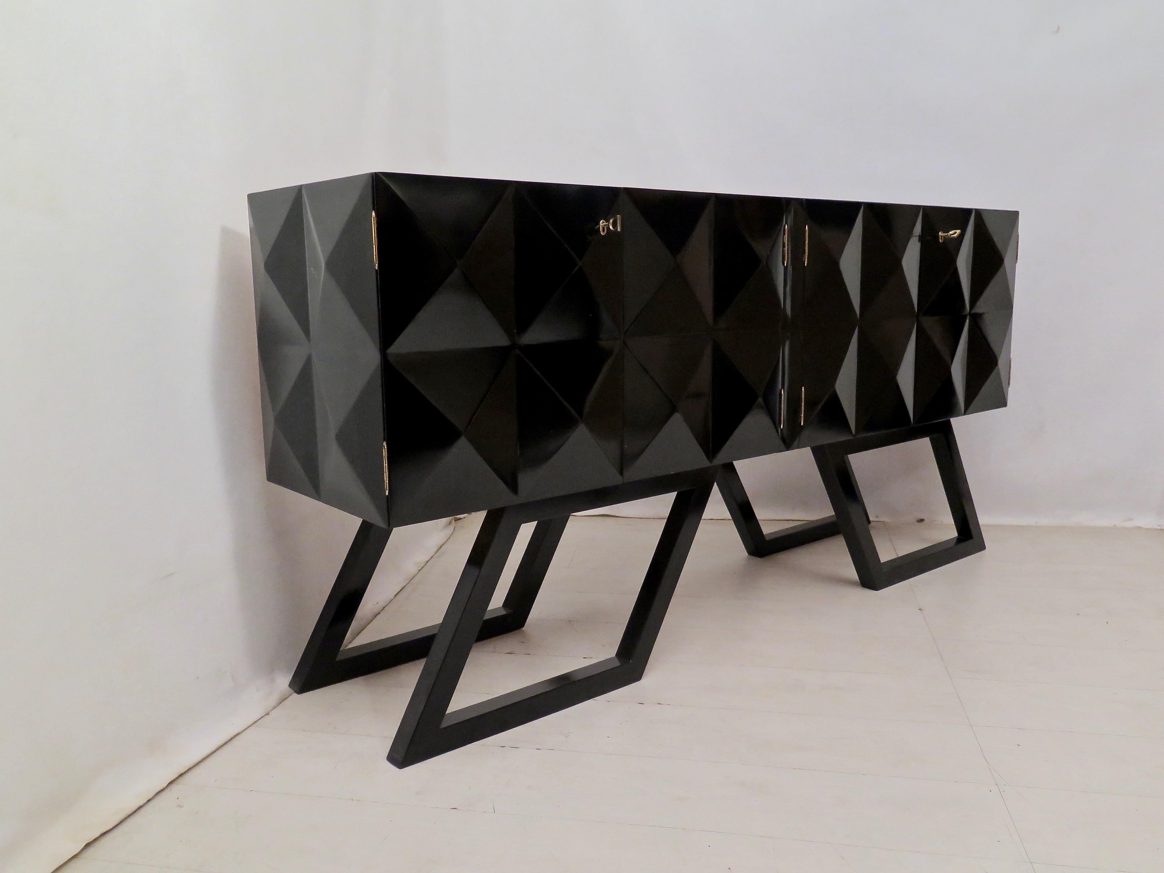 Sideboards of the middle of the century. All polished in black shellac. The structure is in wood, the top is smooth and polished in black shellac, the front and sides have a design formed by a series of pyramids with a square base. There are four