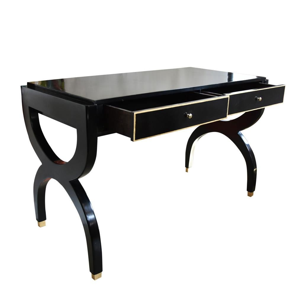 An exceptional writing desk / console black lacquered wood with gilt leaf decorations on drawers and feet, brass handles bent wood arched legs.
This desk is a very good example of the elegance, quality and craftsmanship of the midcentury Italian
