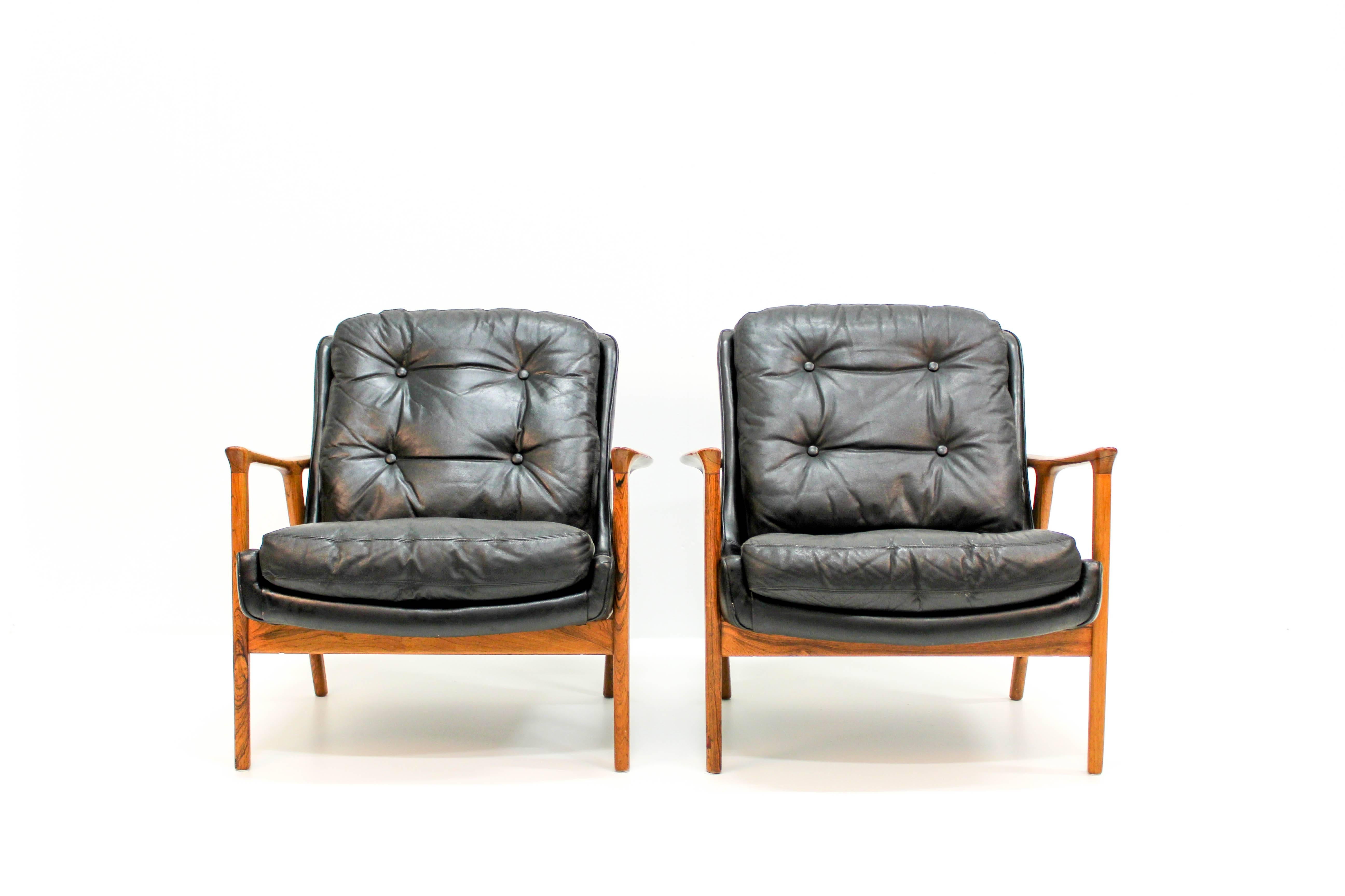 Midcentury lounge chairs by Inge Andersson for Bröderna Andersson. These chairs has original black leather upholstery and rosewood frames. High comfort combined with high quality materials makes these chairs both decorative and comfortable.