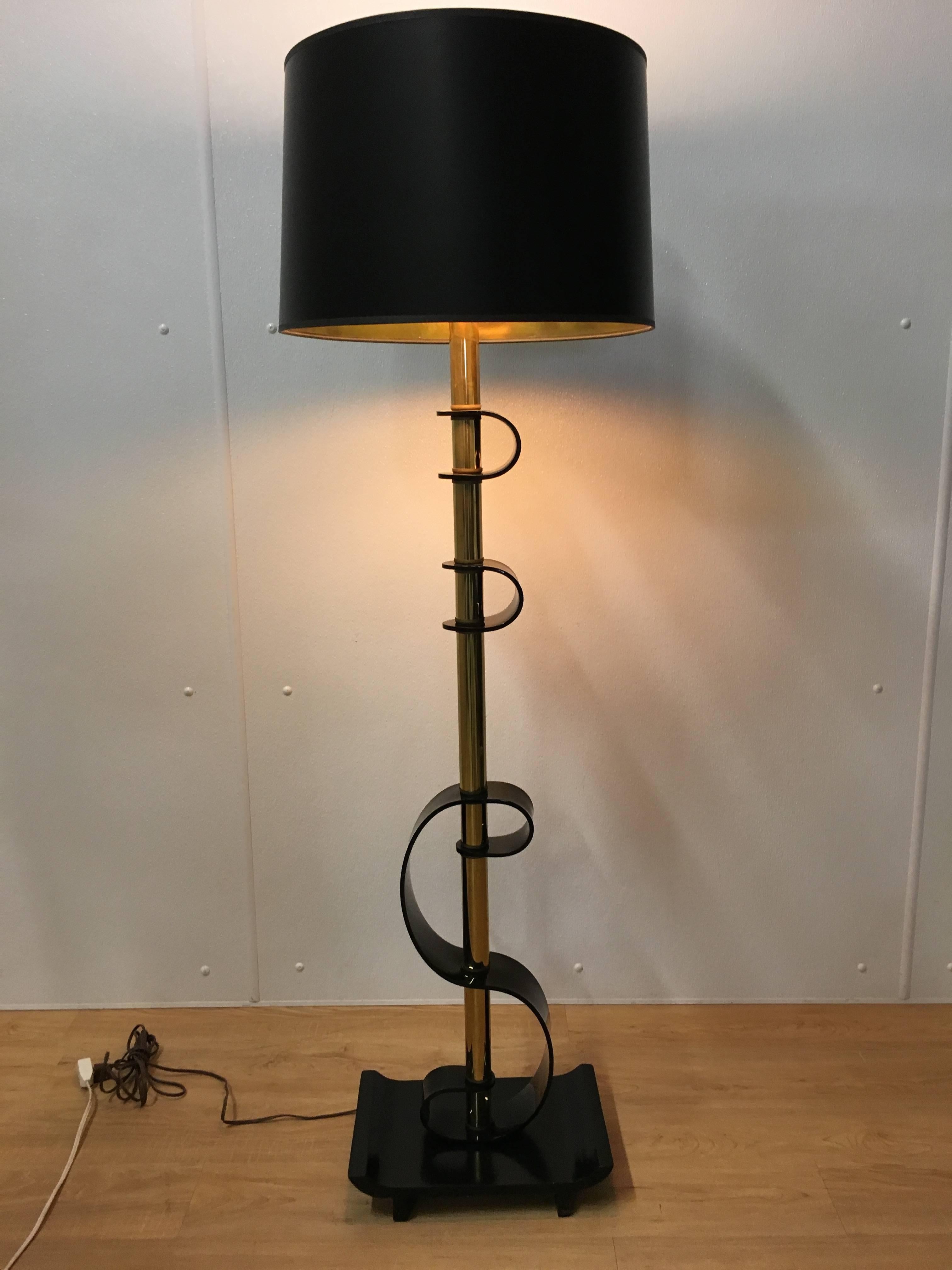 Great midcentury black Lucite floor lamp, scrolling Lucite on brass column with ebonized rectangular footed plinth base. Shade for display purposes only.
