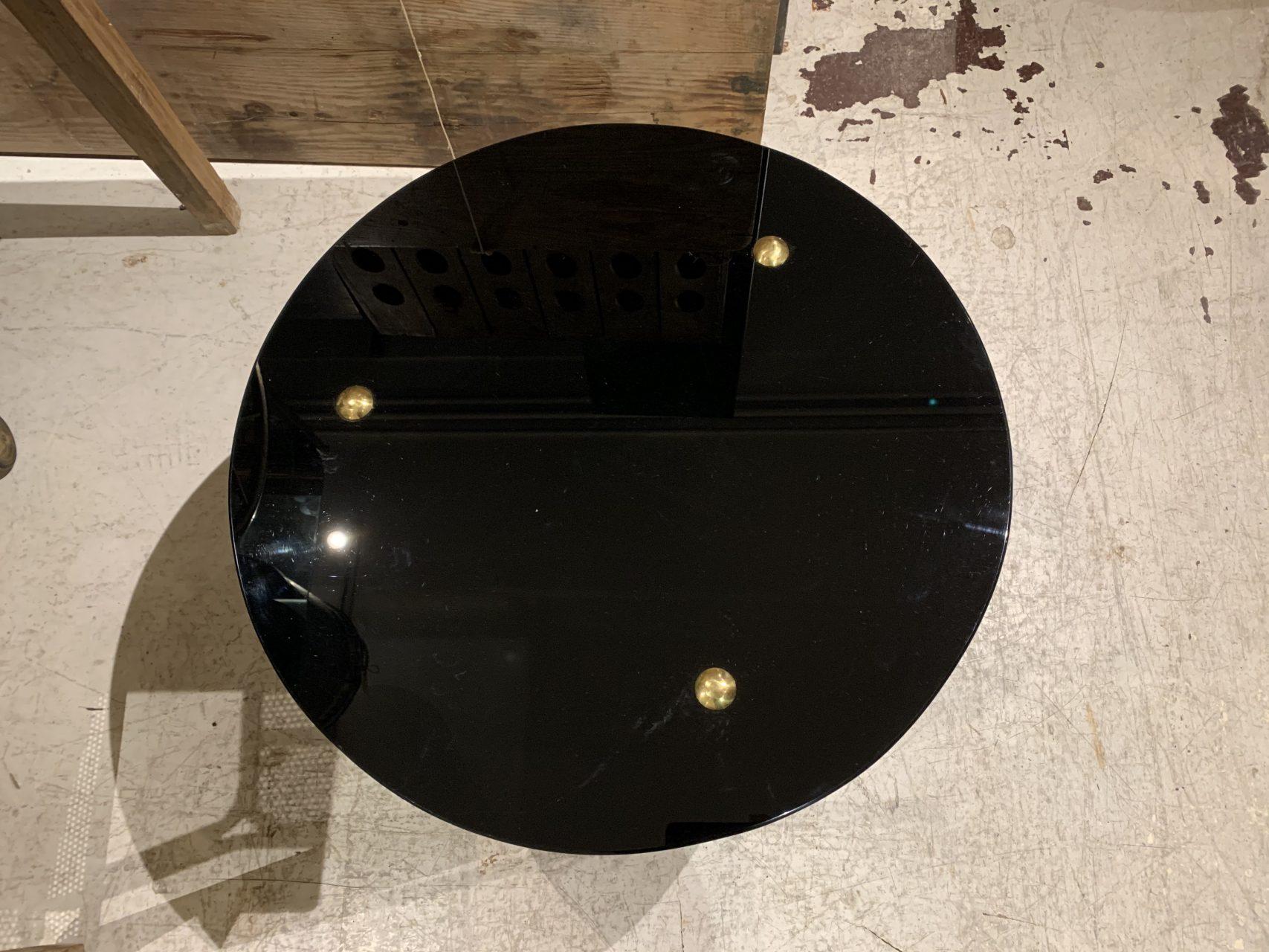 Sophisticated and beautiful circular coffee table in glass and brass from late midcentury, France. Elegantly made with 3 slender fluted brass legs and 2 strong round opaque black glass, giving an exclusive look.

Perfect furniture for the living