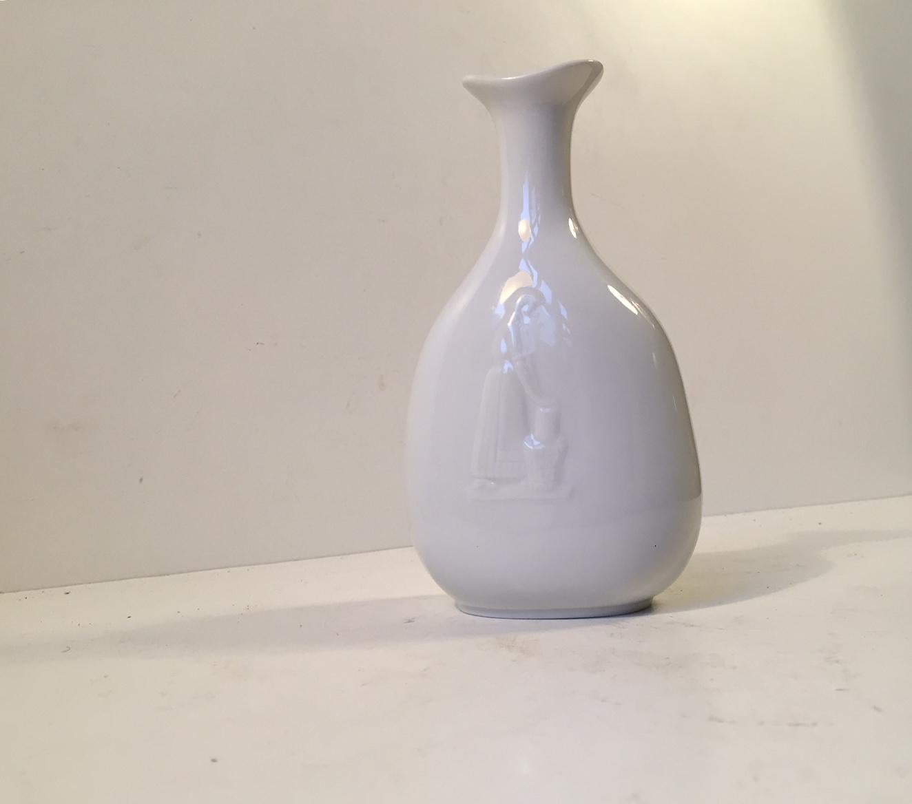 A Blanc de Chine vase design by Swedish ceramist Gunnar Nylund for Hellerupis (Hellerup Ice Cream) in Denmark. The front depicts a woman making ice cream. This vase was made as a commercial gift in a relatively limited amount and only in Denmark in
