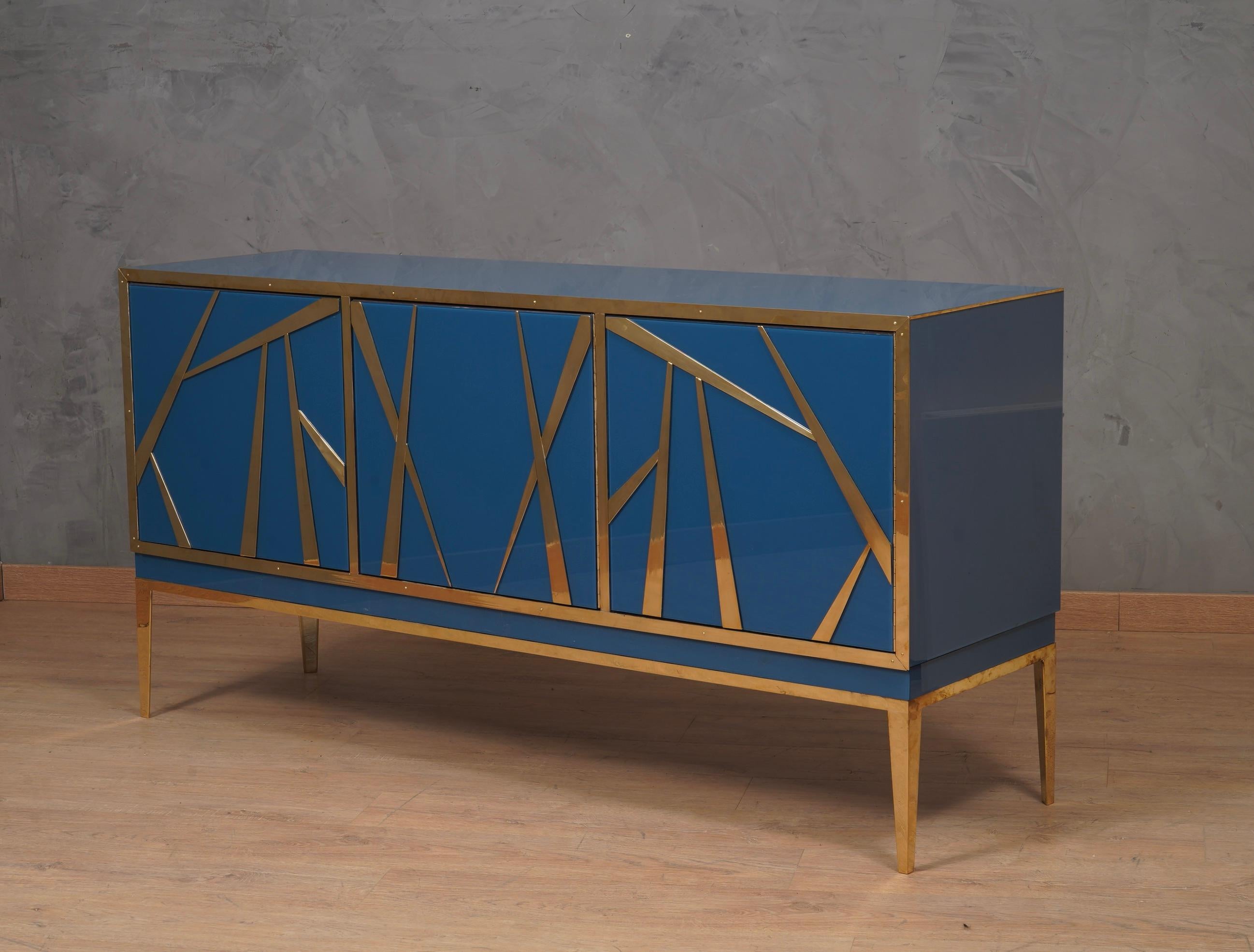 A one-of-a-kind sideboard for its originality and choice of materials. Simple but refined design. Note the rich design of the doors, with smooth colored glass interspersed with brass mouldings.

The sideboard has a wooden structure, which was then