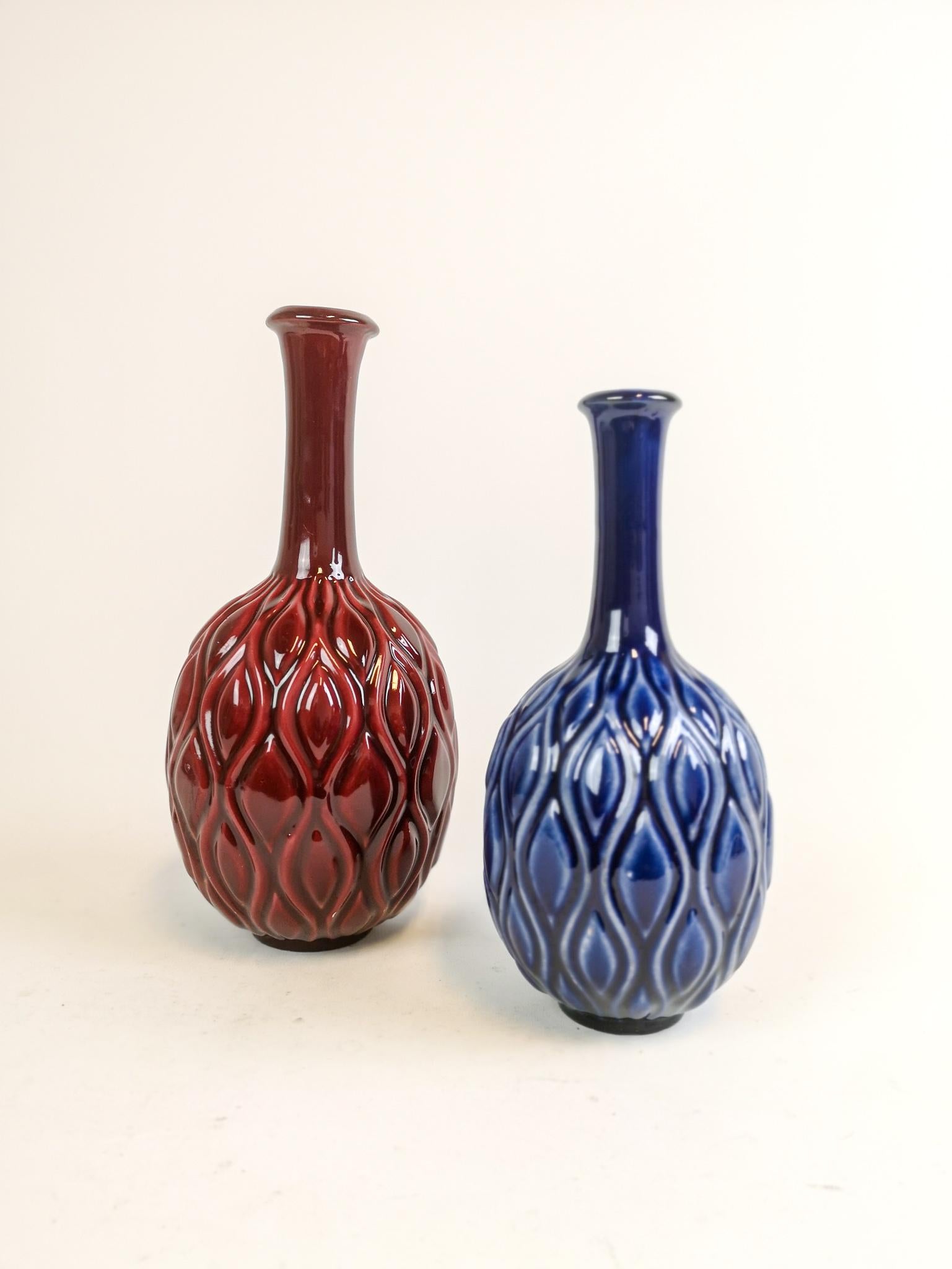 Wonderful blue and red ceramic vases in peacock looking pattern. Designed by Sven Erik Skawonius for Upsala Ekeby, Sweden, 1954.

Very good condition

Measures: Blue H 25 cm, D 12 cm. and Red H 29, D 14 cm.
 