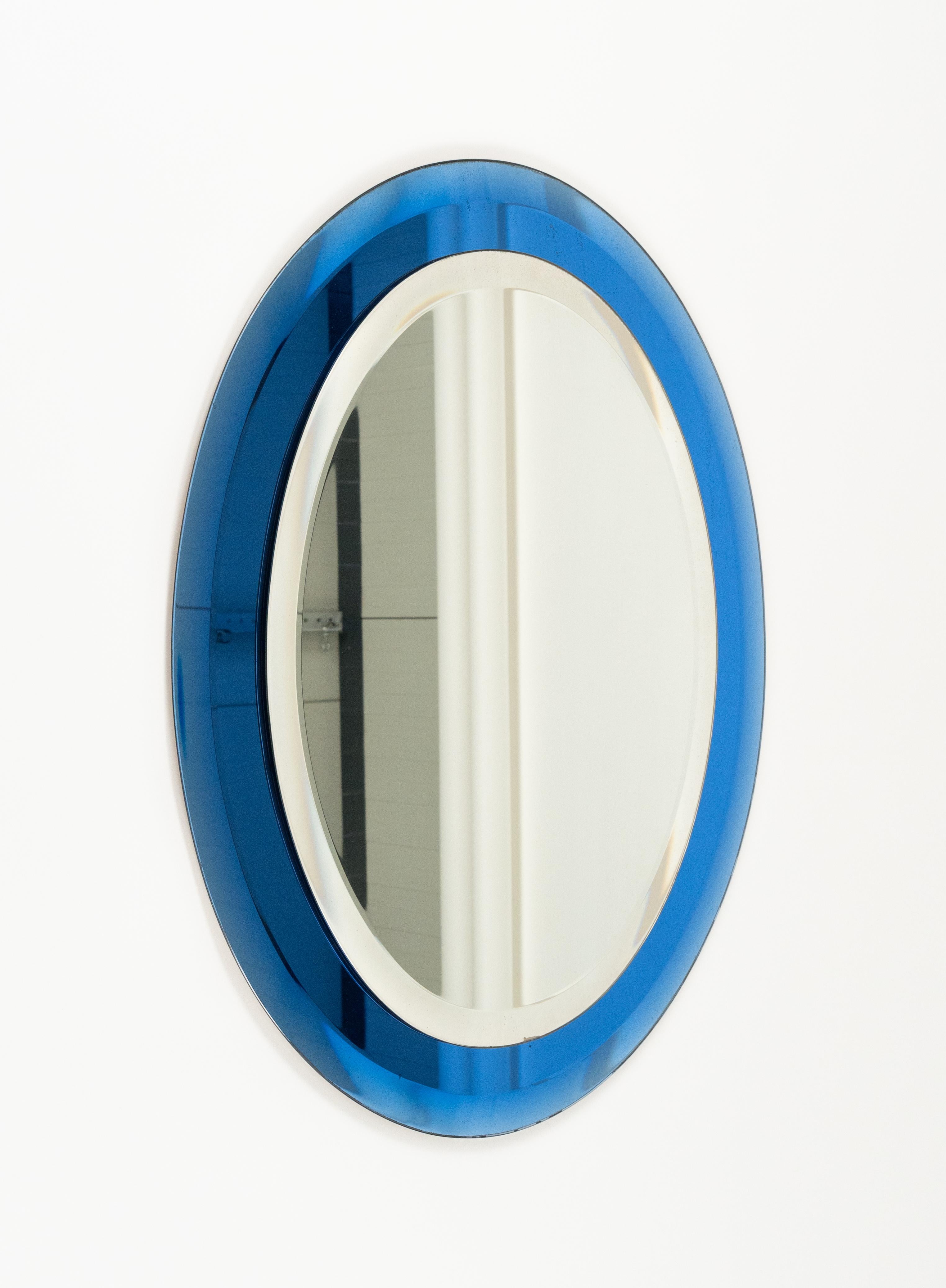 Midcentury amazing oval wall mirror with blue frame by Antonio Lupi for Cristal Luxor.

Made in Italy in the 1960s.

The original label is still attached as shown in the pictures.