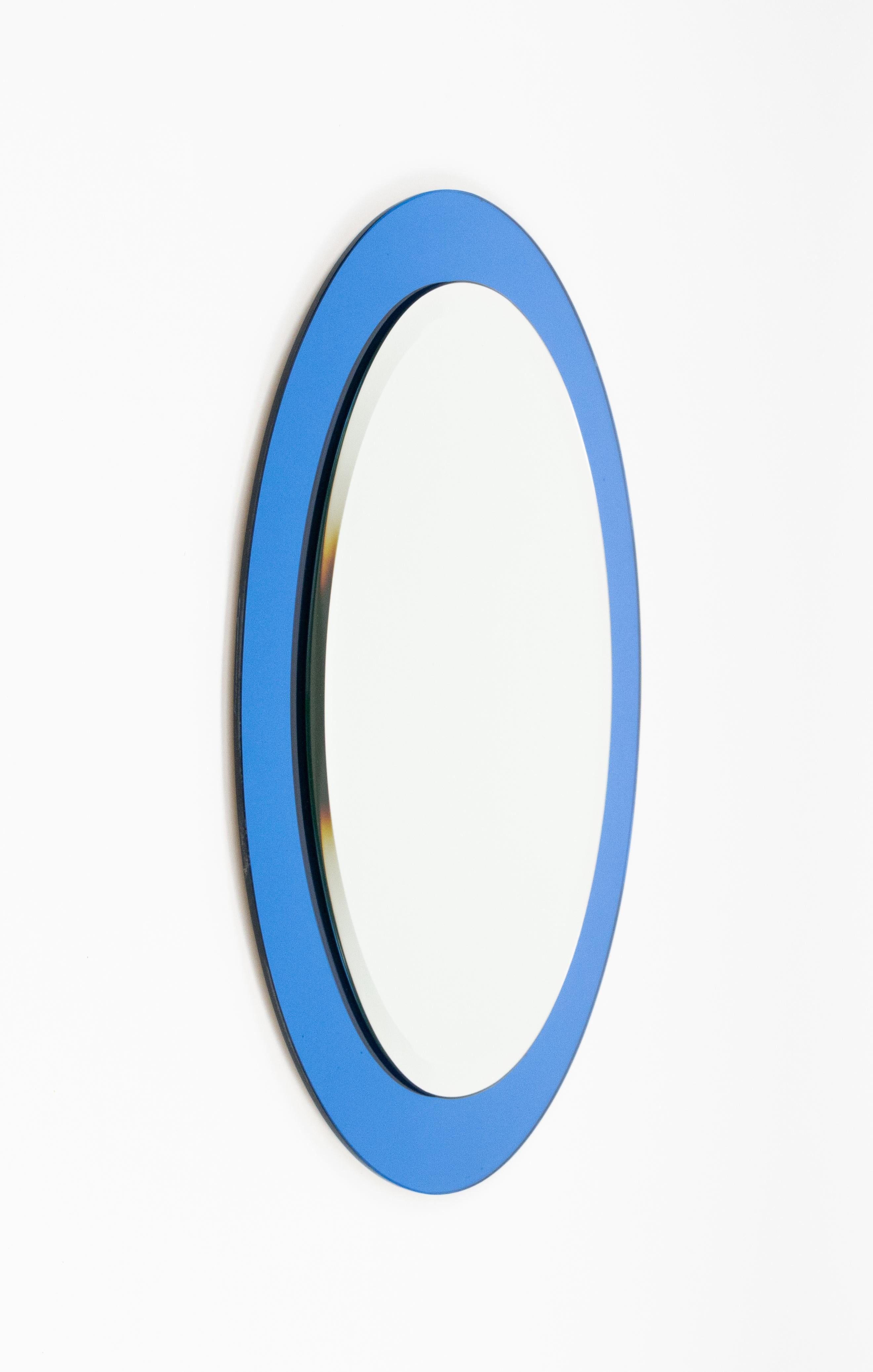 Midcentury amazing oval wall mirror with blue frame by Antonio Lupi for Cristal Luxor.  

Made in Italy in the 1960s.  

The original label is still attached as shown in the pictures.
