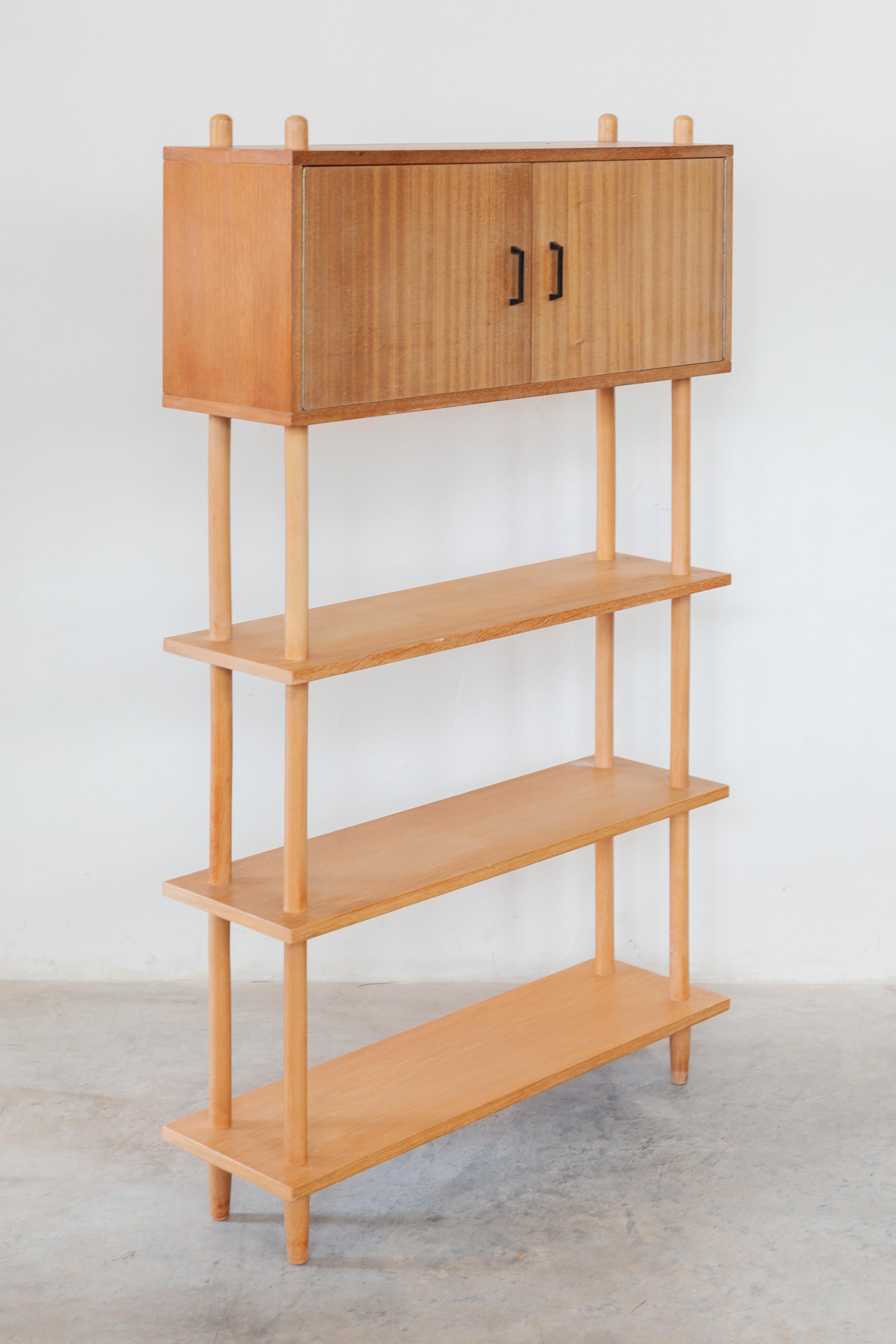 Free standing book stand stick cabinet designed by Lutjens De Boer, The Netherlands 1960s. A special feature of this stick cabinet is the closed compartment, which makes it practical and decorative. Can be used as a cupboard or room divider