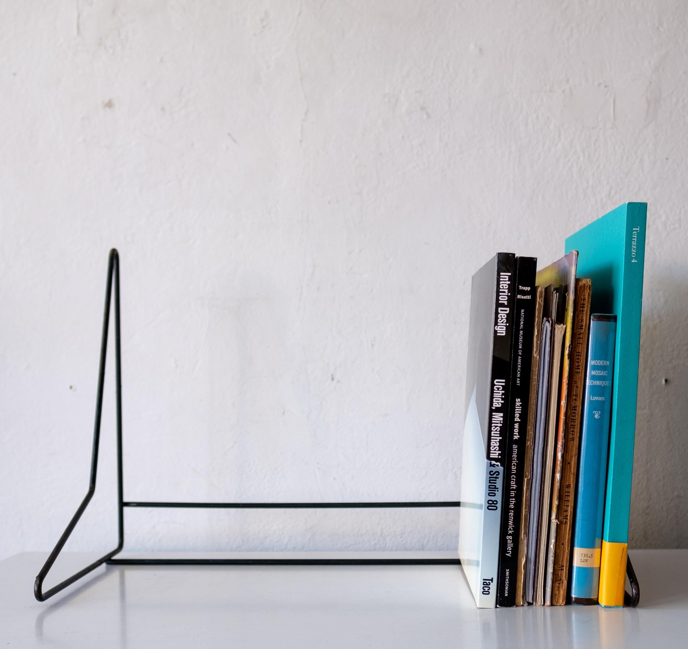 Modernist book stand from the 1950s. Great design for use on a desk or table. Black enameled metal.