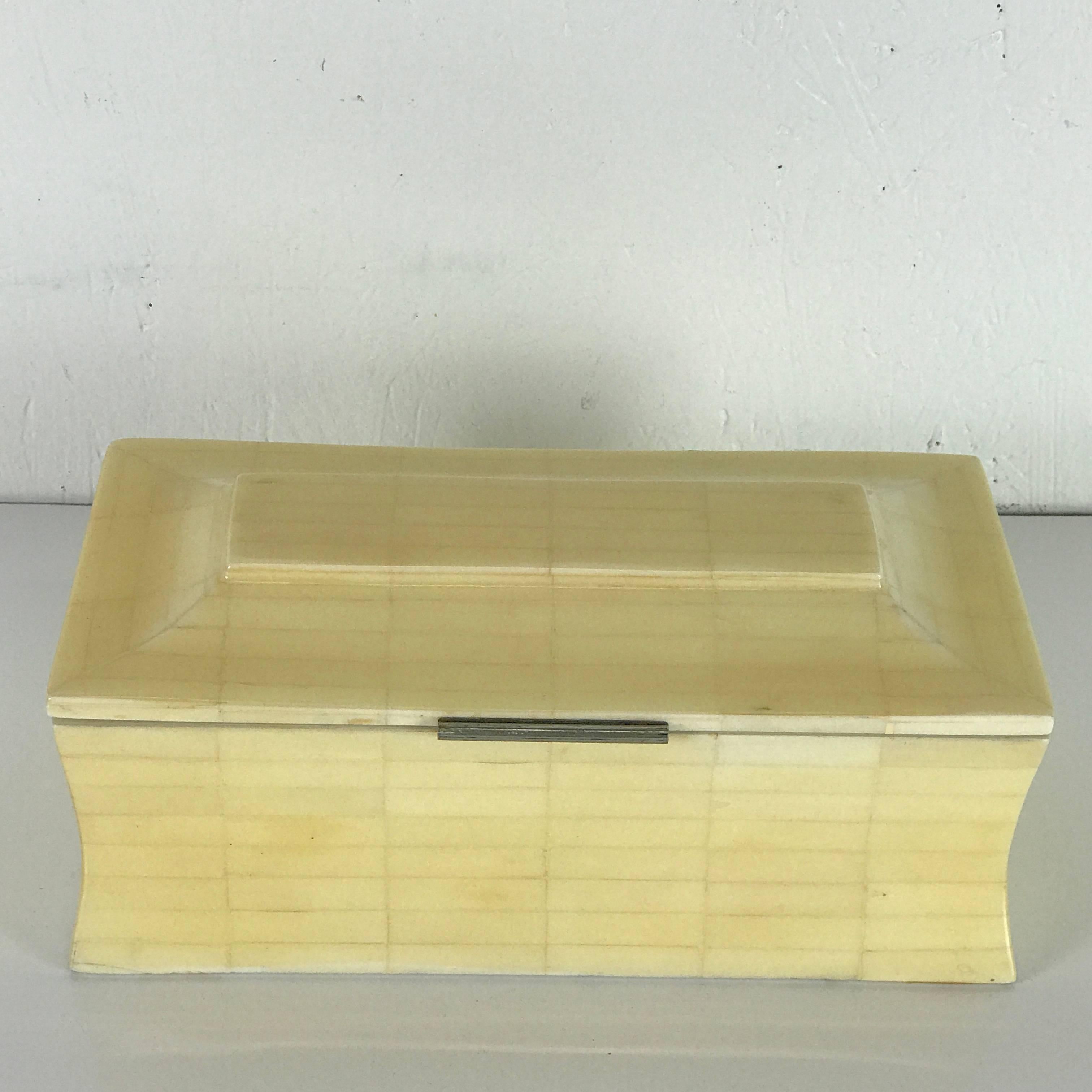 Midcentury bookmatched bone table box, sarcophagus form with silver-plated mounts and wood lined interior.