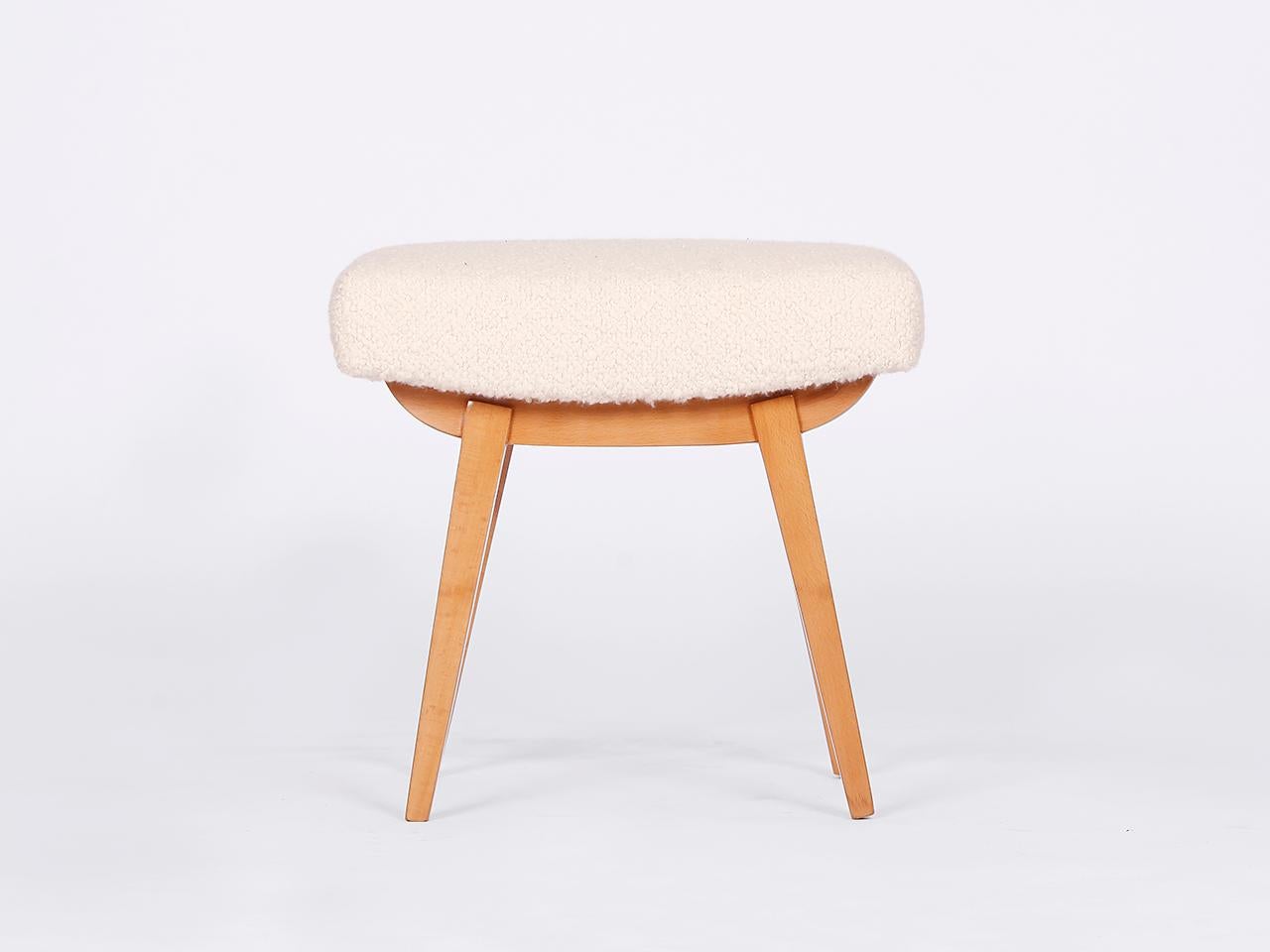 This mid-century stool footstool was made in the 1960s in former Czechoslovakia. The upholstery consists of a coconut fiber core, covered with a wonderful bouclé fabric made of soft wool and alpaca. Completely restored.
