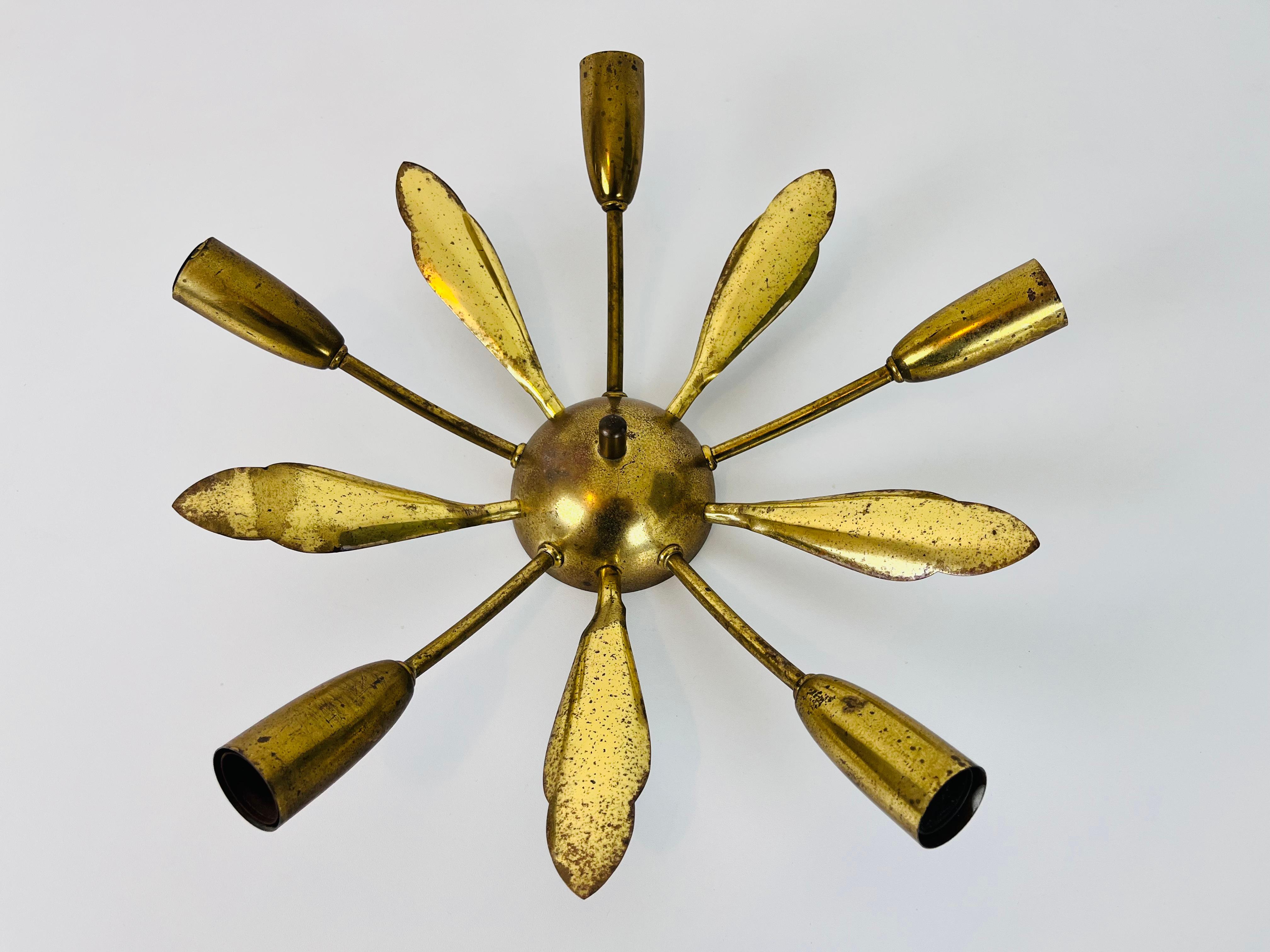 A brass Sputnik chandelier made in Germany in the 1950s. It is fascinating with its five brass arms, each of it with an E14 light bulb. The shape of the light is similar to a spider.

The light requires 5 E14 light bulbs. Works with both 120/220
