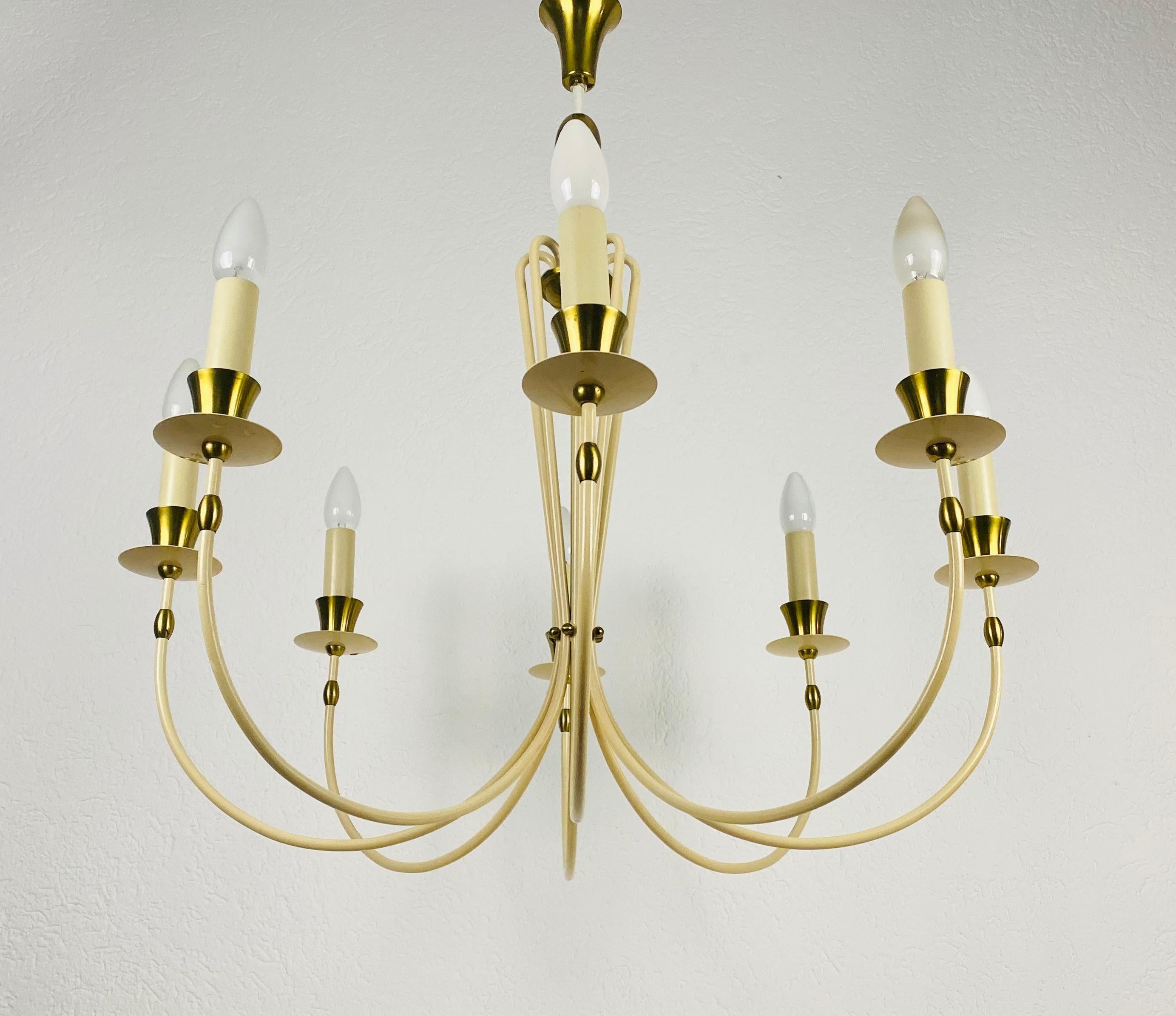 A midcentury chandelier made in Germany in the 1960s. It is fascinating with its rare arms and elegant design.

The light requires eight E14 light bulbs. Works with both 220V/120V. Good vintage condition.

Free worldwide express shipping.