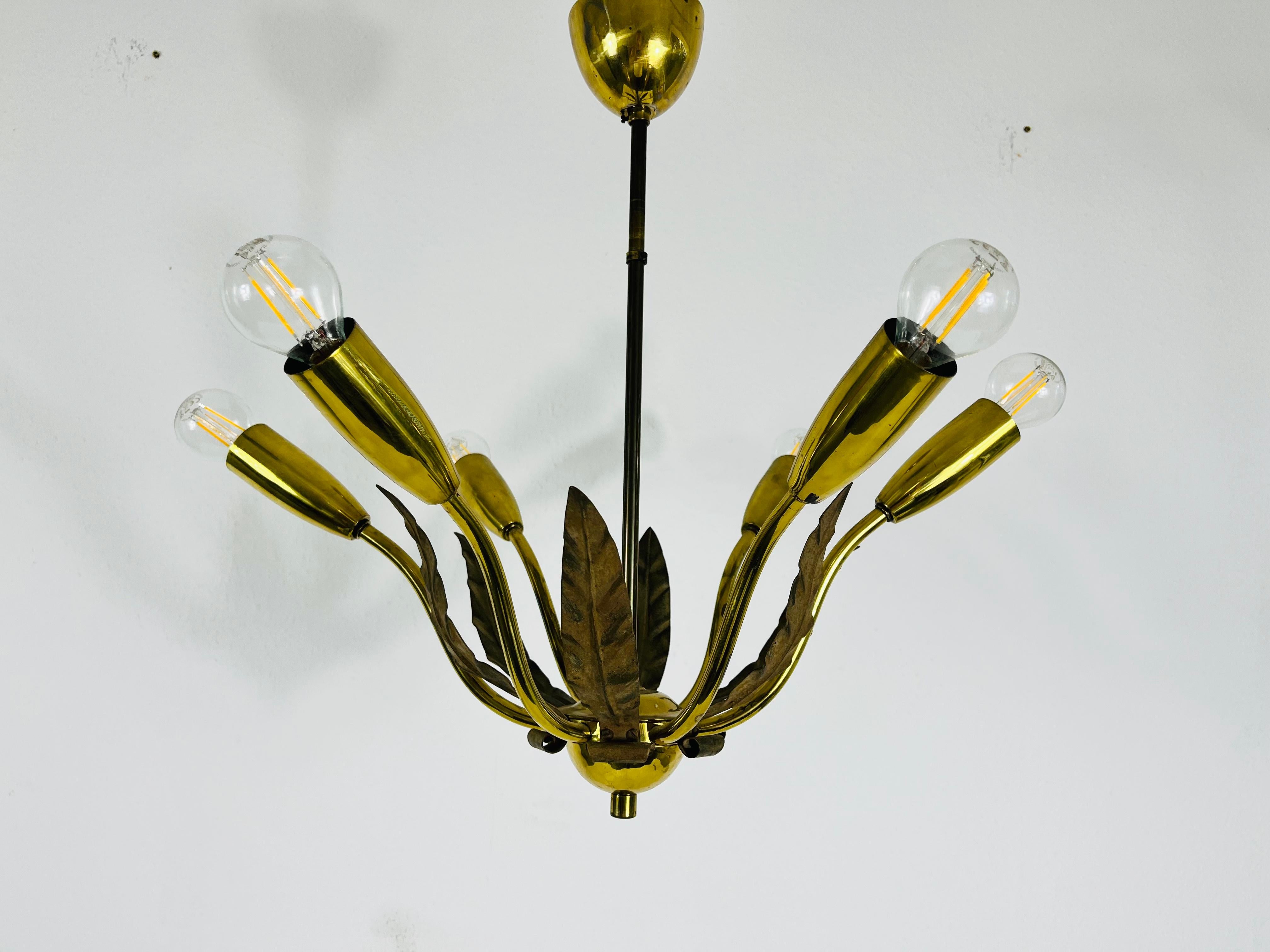 A midcentury chandelier made in Germany in the 1960s. It is fascinating with its rare arms and elegant design.

The light requires eight E14 light bulbs. Works with both 220V/120V. Good vintage condition.

Free worldwide express shipping.