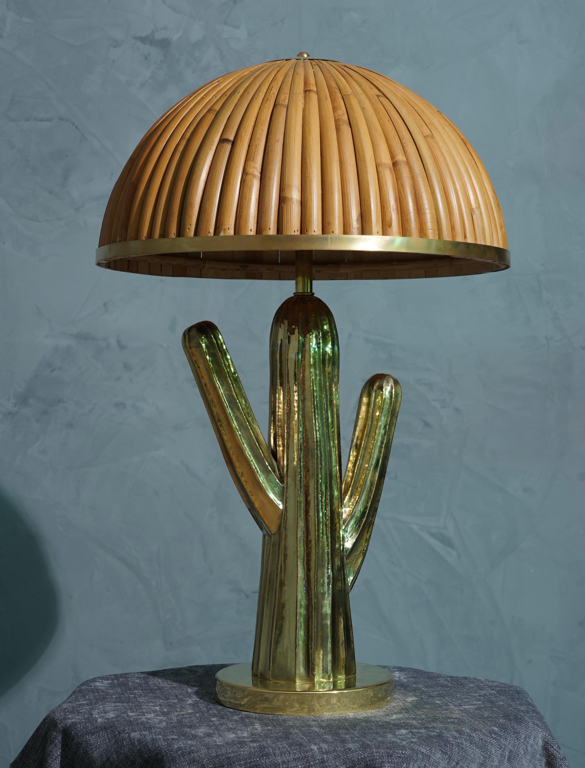 Very original design lamp that recalls the shape of a cactus, one of a kind hat.

The lamp was made with a smelting of brass, reminiscent of the shape of a cactus, with a large central body and two side arms. it was placed on a brass base, while on