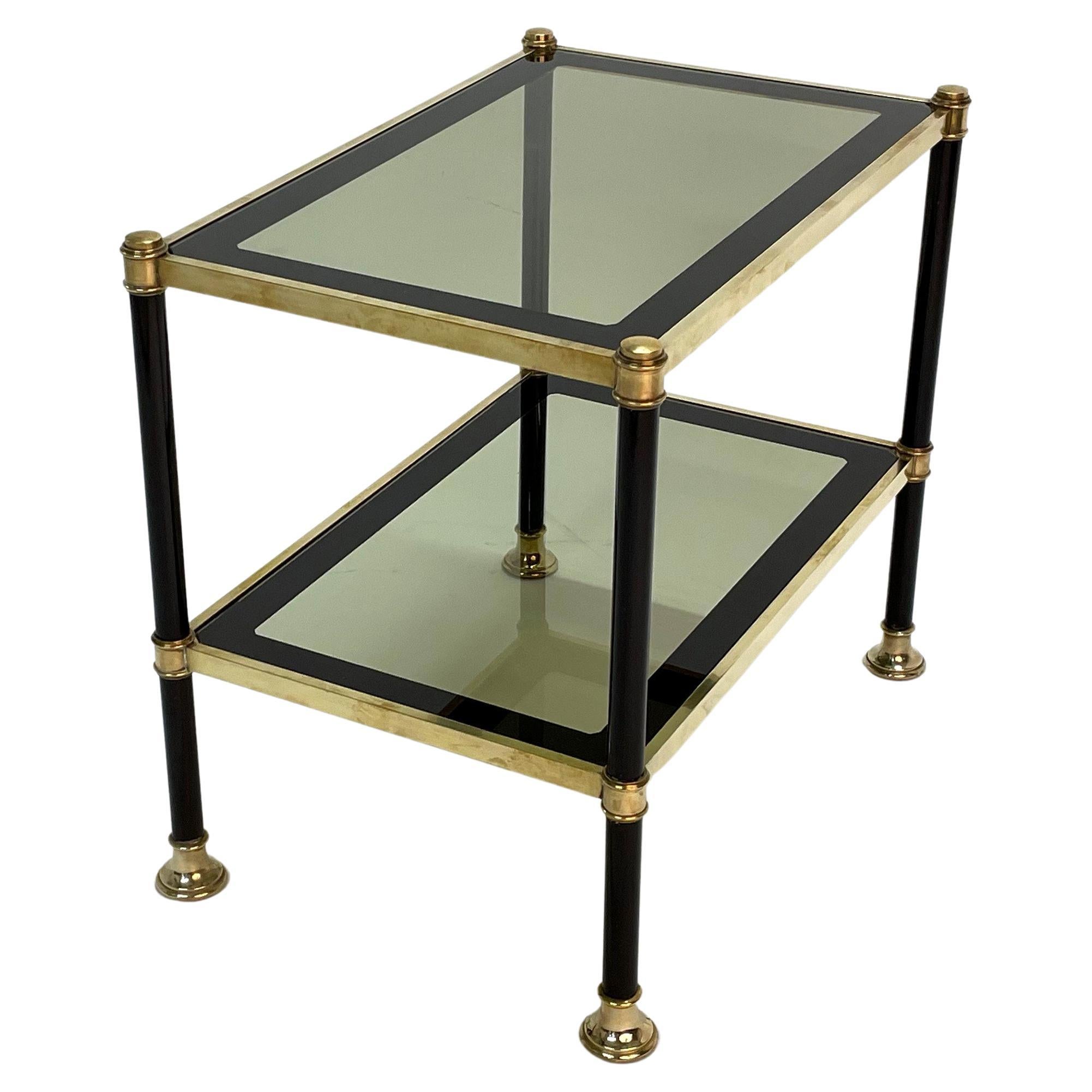 Amazing midcentury mirrored brass and smoked glass coffee table. This fantastic piece was designed in Italy during the 1970s and is attributed to the Maison Jansen. 

This two-tier mid-century rectangular coffee table is incredible as it comes
