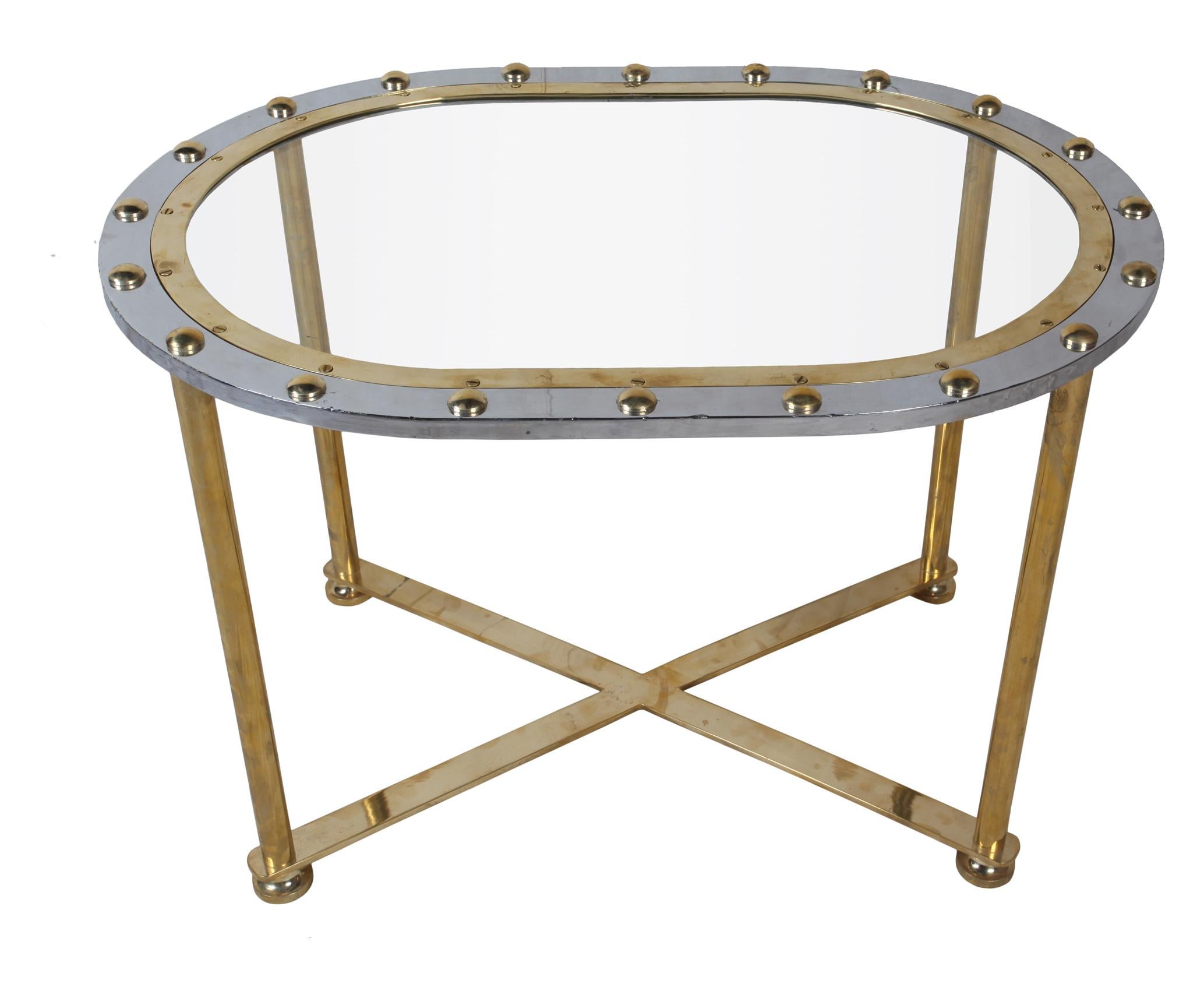 A lovely combination of brass and chrome-over-brass original ship's window, converted into a coffee table. The rivets have been put back in as these pop out when taken off ships, and the base is our original design and can easily be taken apart for