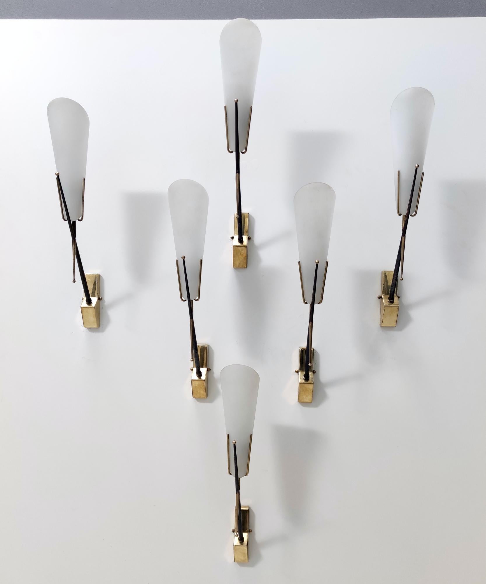 Italy, 1950s. 

These sconces are made in etched and sandblasted glass, brass and iron. 
Price per item. They are vintage, therefore they might show slight traces of use, but they can all be considered as in excellent original condition and ready to