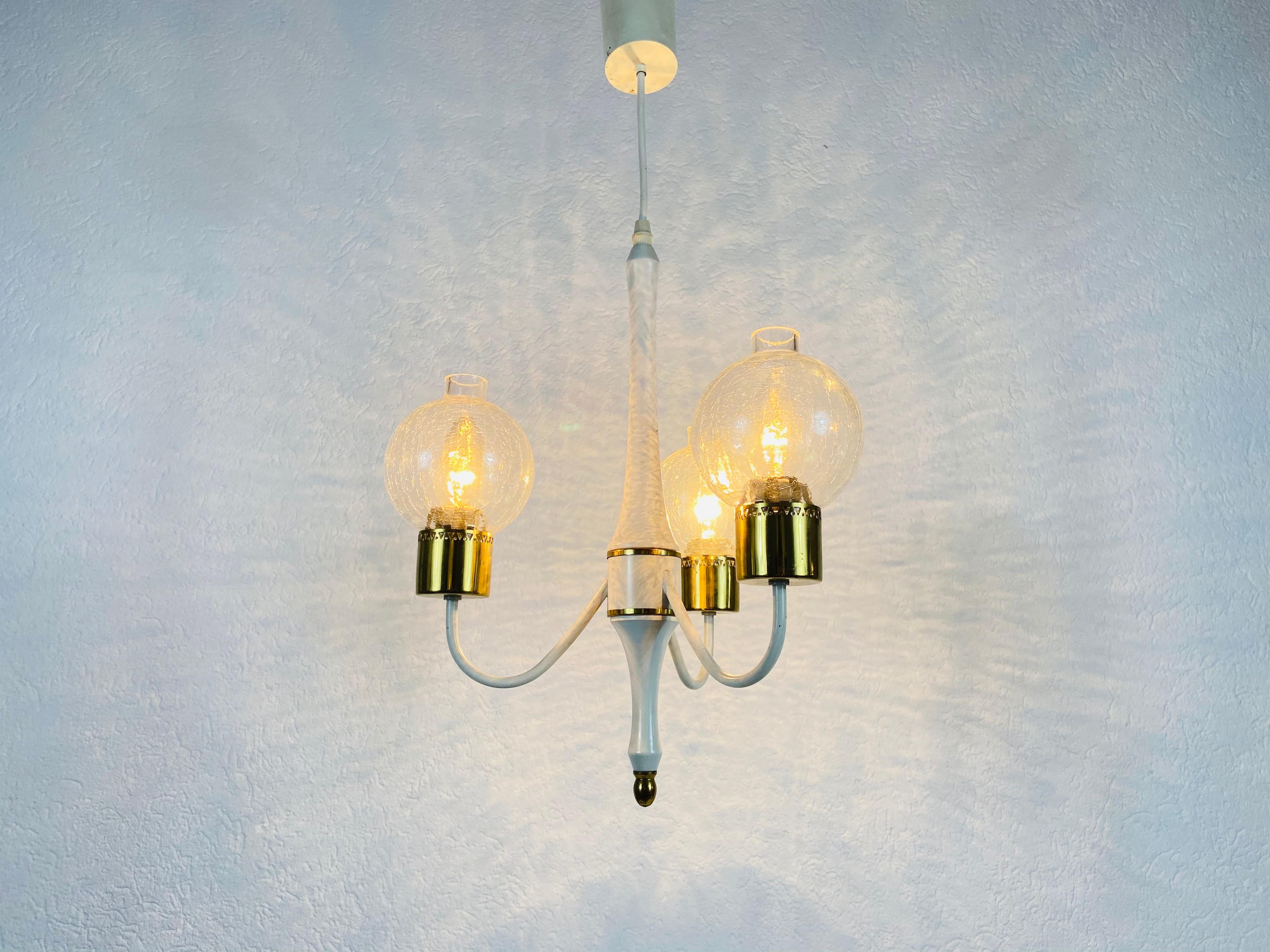 A midcentury chandelier made in Germany in the 1960s. It is fascinating with its rare arms and elegant design.

The light requires three E14 light bulbs. Works with both 120/220V. Good vintage condition.

Free worldwide express.
