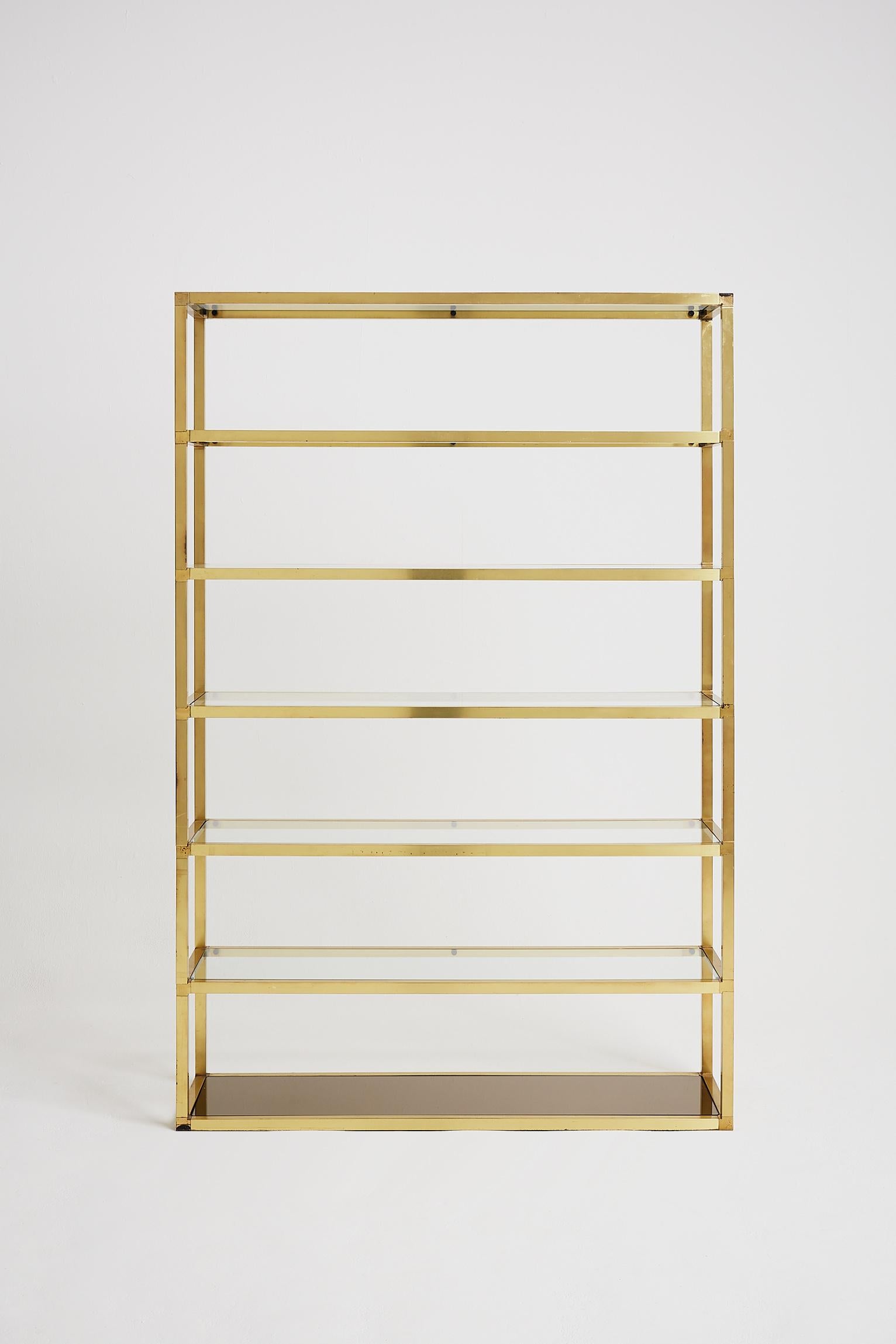 A large seven-tier brass and glass étagère, the lower shelf with a smoked mirror,
France, circa 1970.
