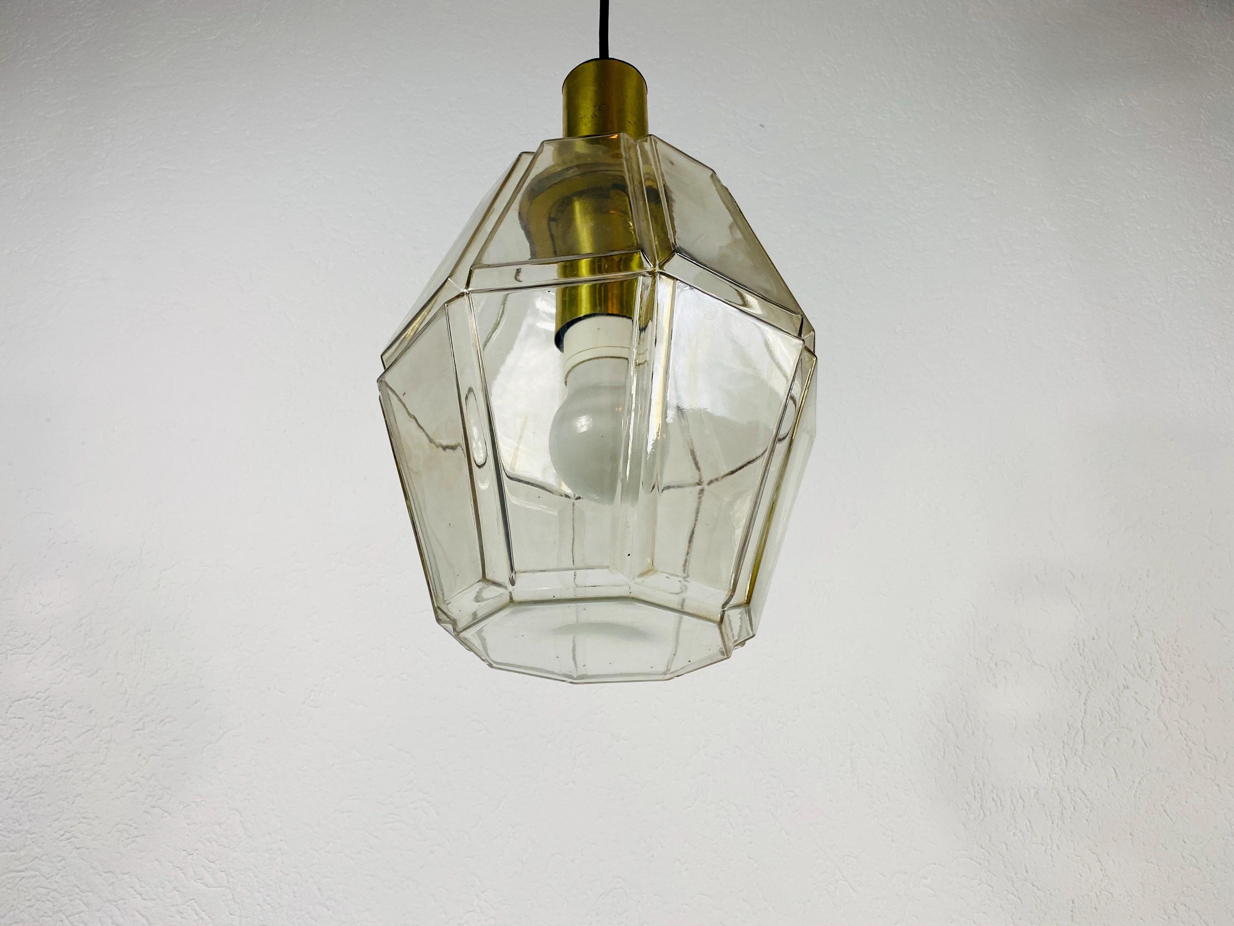 A Mid-Century Modern pendant lamp by Glashütte Limburg made in the 1960s in Germany. It is fascinating with its beautiful structured glass. The fixture has a very nice Minimalist design.

The light requires one E27 light bulb.