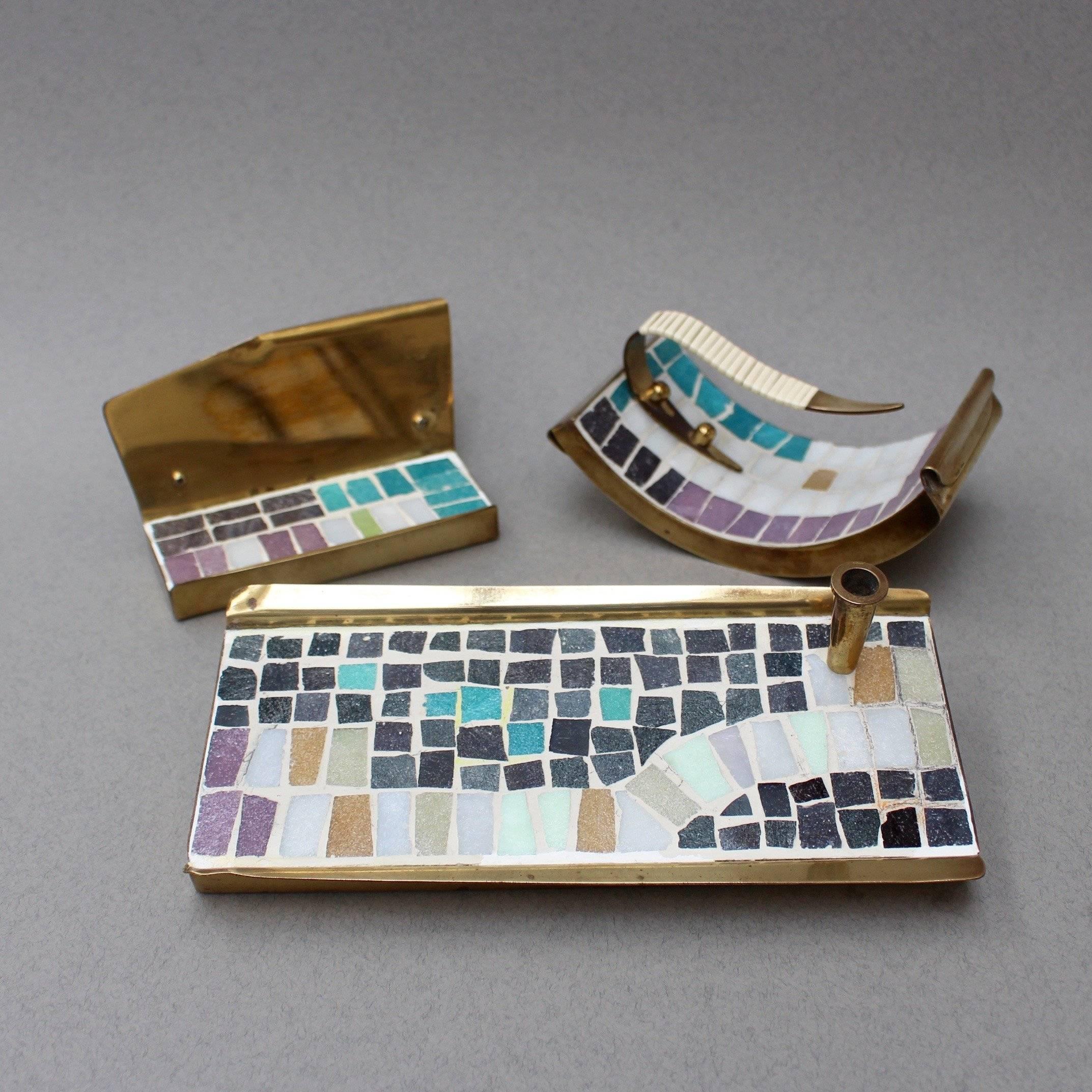 Midcentury brass and mosaic tile desk accessories set, circa 1960s. The set consists of a sizeable and weighty pen holder, a business card rest and a one-of-a-kind rocker blotter. This ensemble is so perfectly 'Mad Men' elegant and of the period and