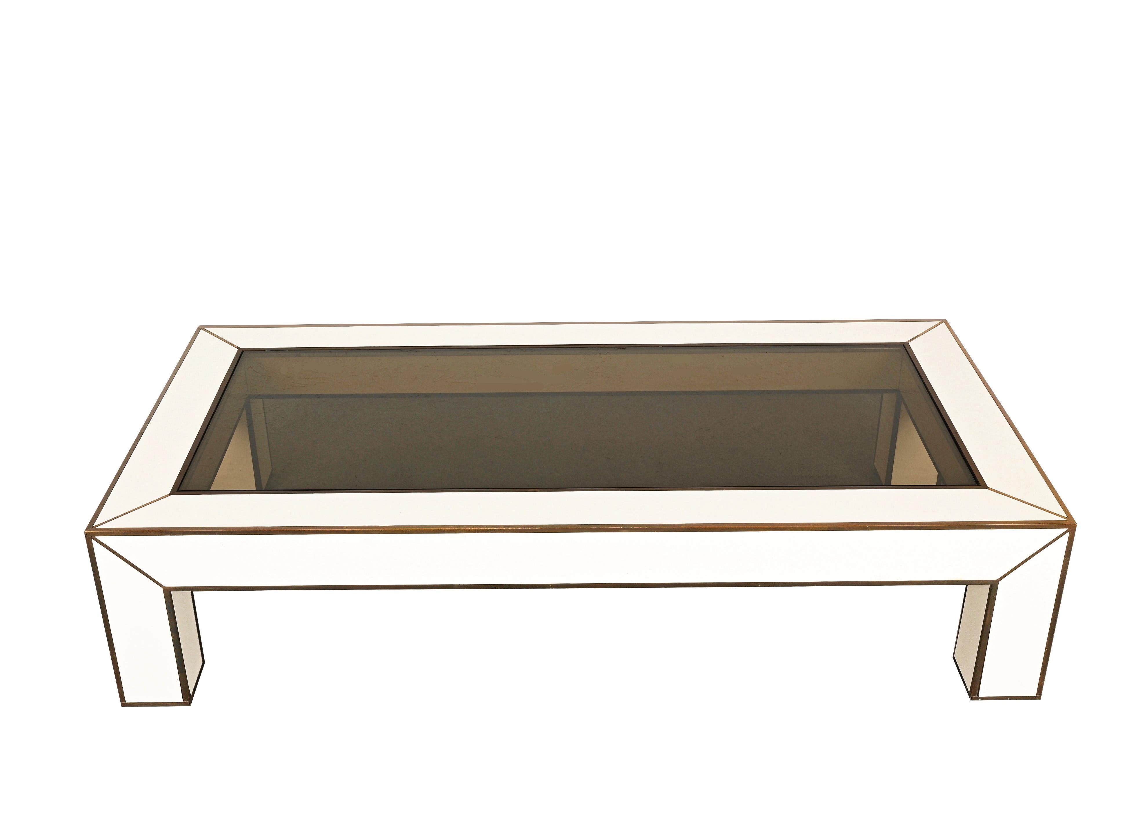 Fantastic and large mid-century low table in brass and white formica laminate. This wonderful piece is inspired by Willy Rizzo's production and was designed in Italy during the 1970s.

This fantastic item has brass finishes with a beautiful patina