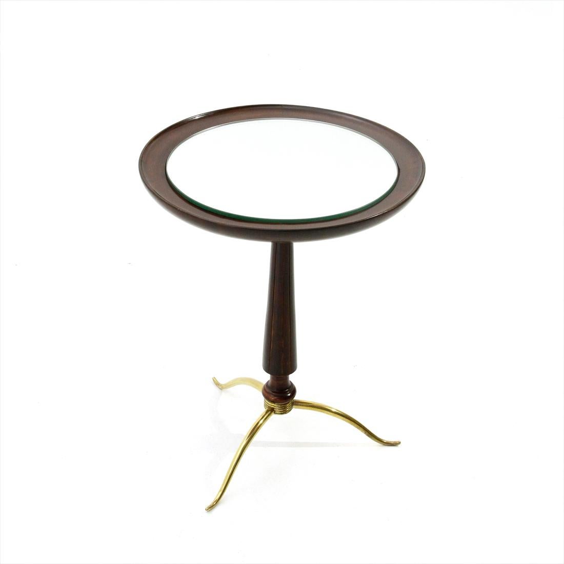 Italian manufacture table produced in the 1940s.
Wooden top and mirrored glass.
Shaped wooden stem.
Brass foot.
Good general conditions, some signs due to normal use over time.

Dimensions: Diameter 38 cm, height 49 cm.
