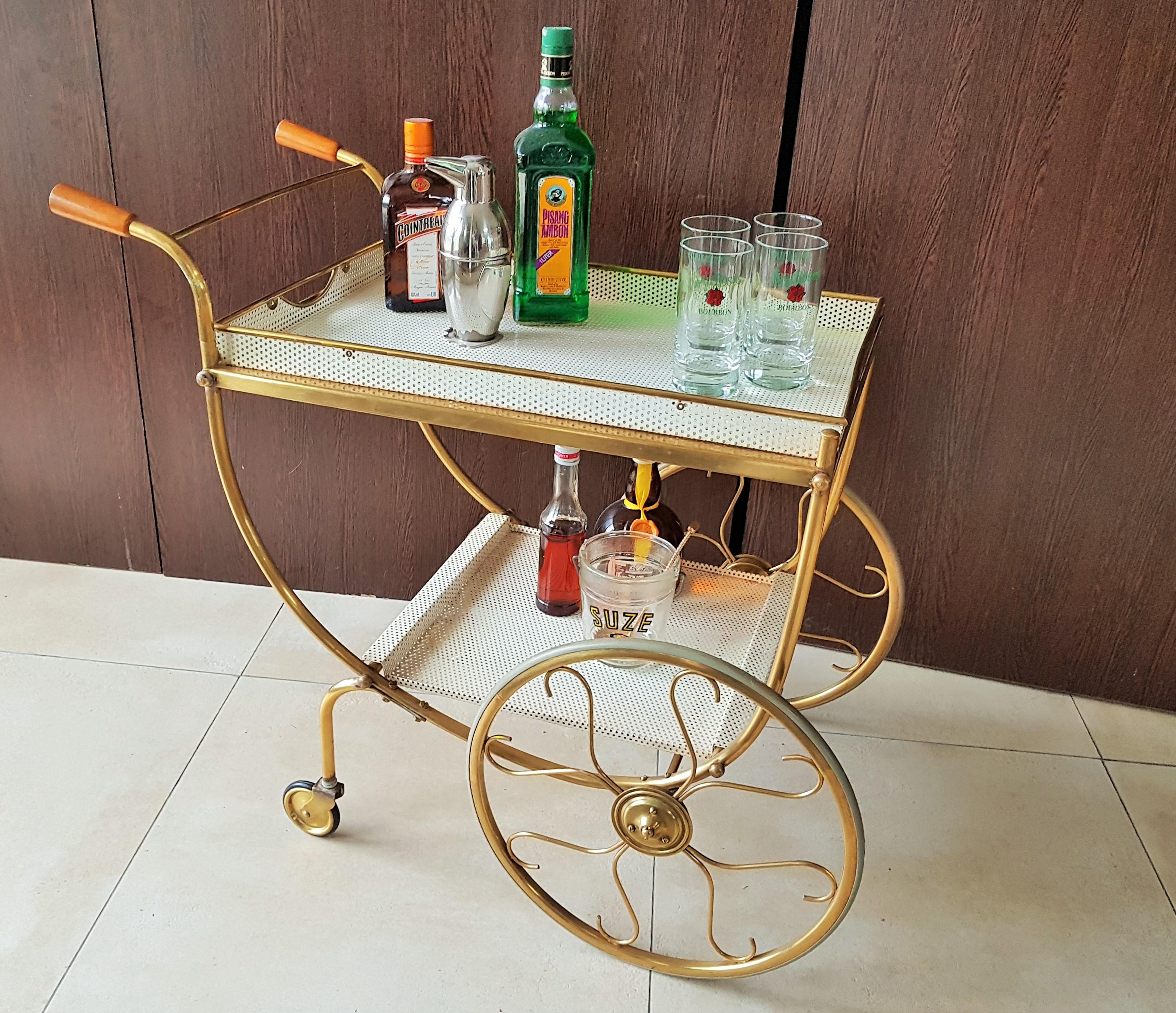 Midcentury brass bar cart by Josef Frank for manufacturer Svenskt Tenn, Sweden, 1950s

Made of tubular and perforated brass. White tin tabletops. Trays removable. Great unrestored original vintage condition.