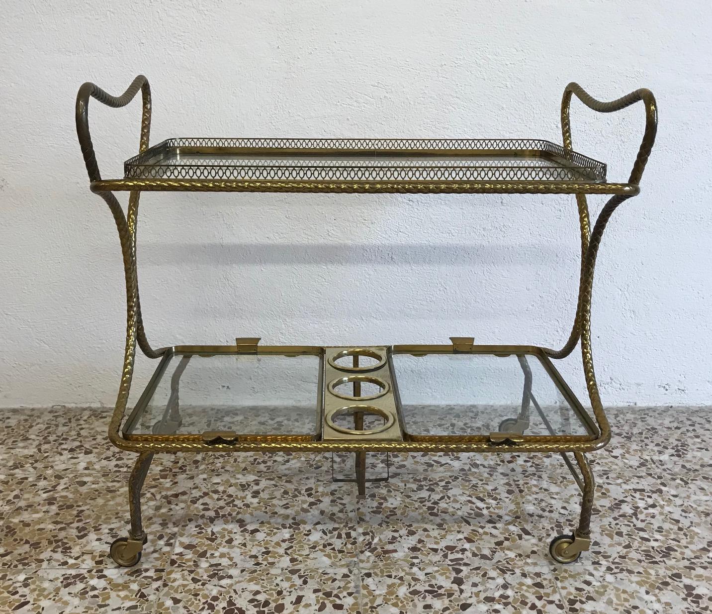 This trolley was produced in Italy in the 1950s.
It is made completely of worked brass with original glass.
The trays are removable.