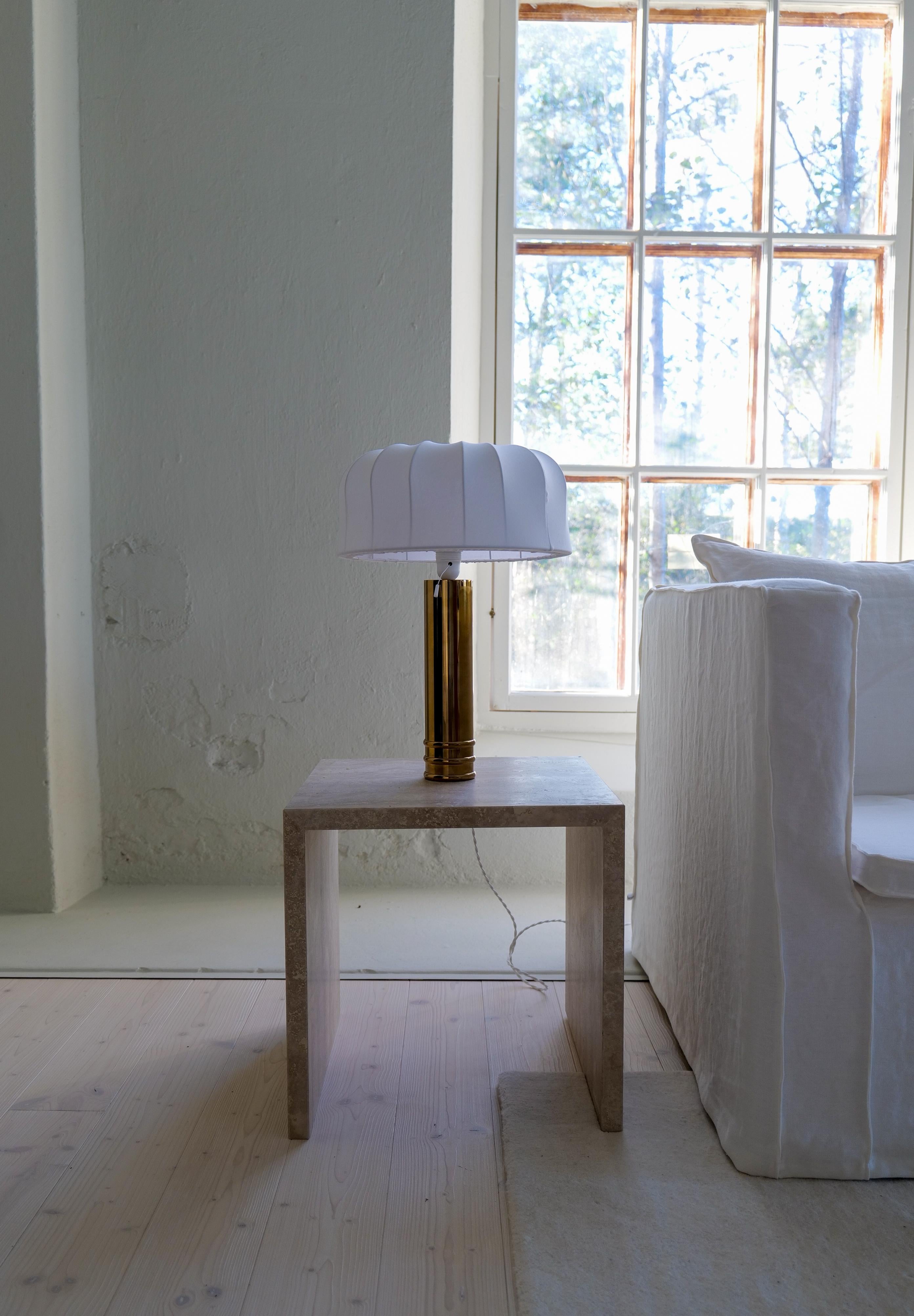 Large and heavy cylinder-shaped table lamp in brass. Bergboms design with all new cotton shades, made in Sweden. Cast iron base finished in brass. This table lamps will give that great look to a vintage home or a twist to the modern home. 

Very