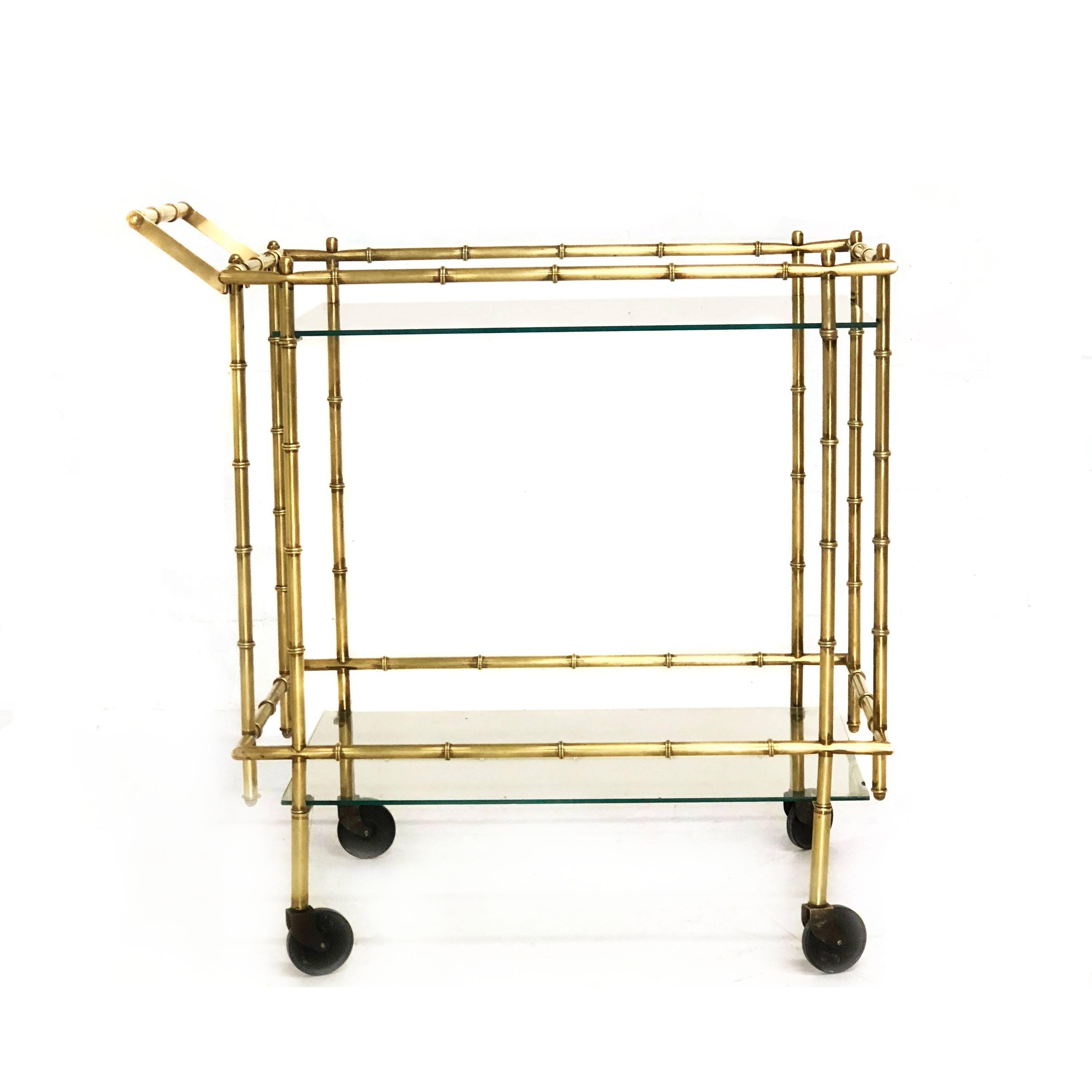 Charming midcentury faux bamboo brass and glass bar cart. In great condition with age appropriate patina. Glass has some minor chipping as seen in pics. 

Measurements: Overall 33.5