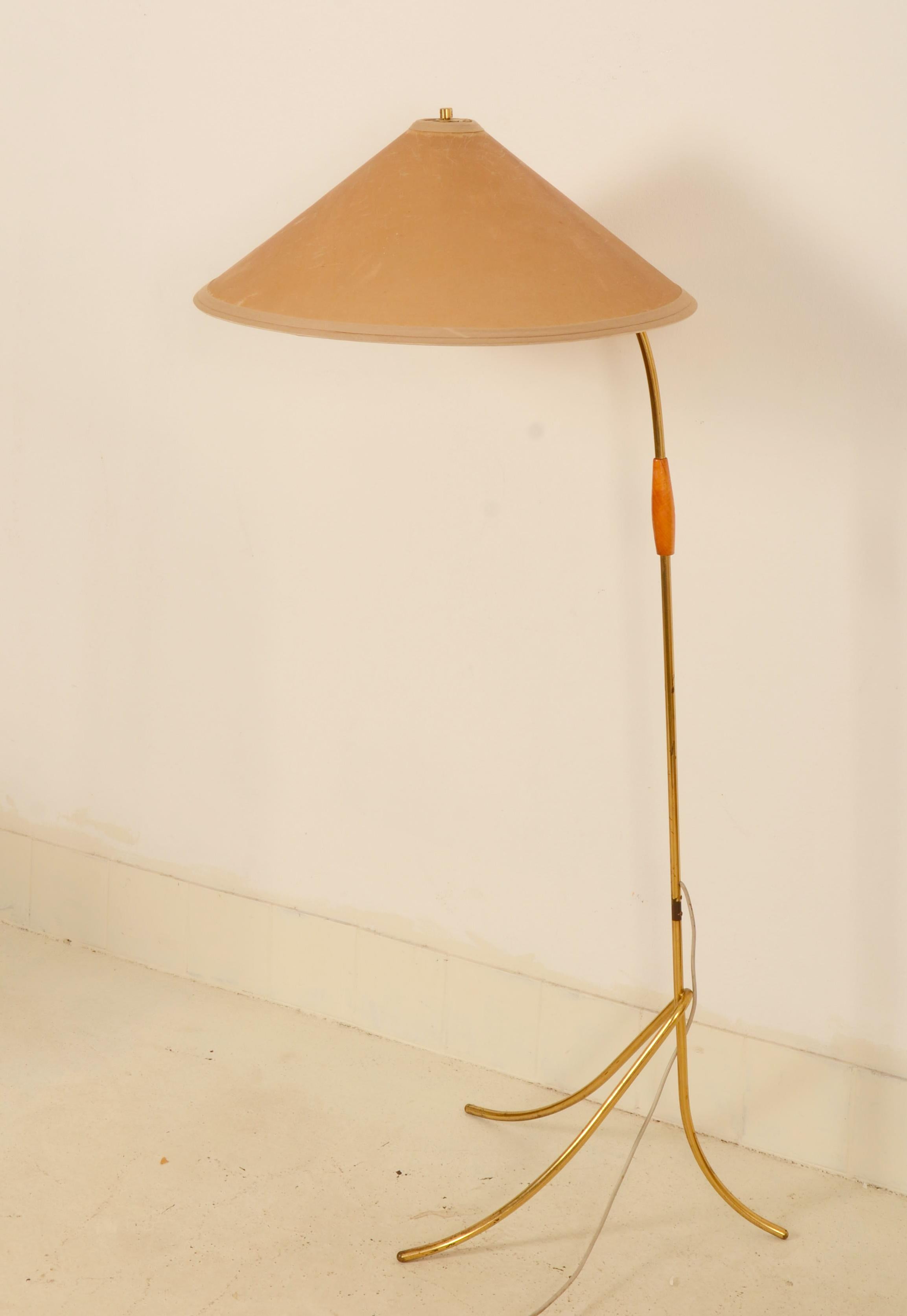 Brass tripod construction fitted with one E27 socket with switch, original parchment cone-shaped tapering, bright lampshade. Desing and manufactured by Rupert Nikoll in Vienna in the 1950s. Signs of age and wear, slight traces of oxidation