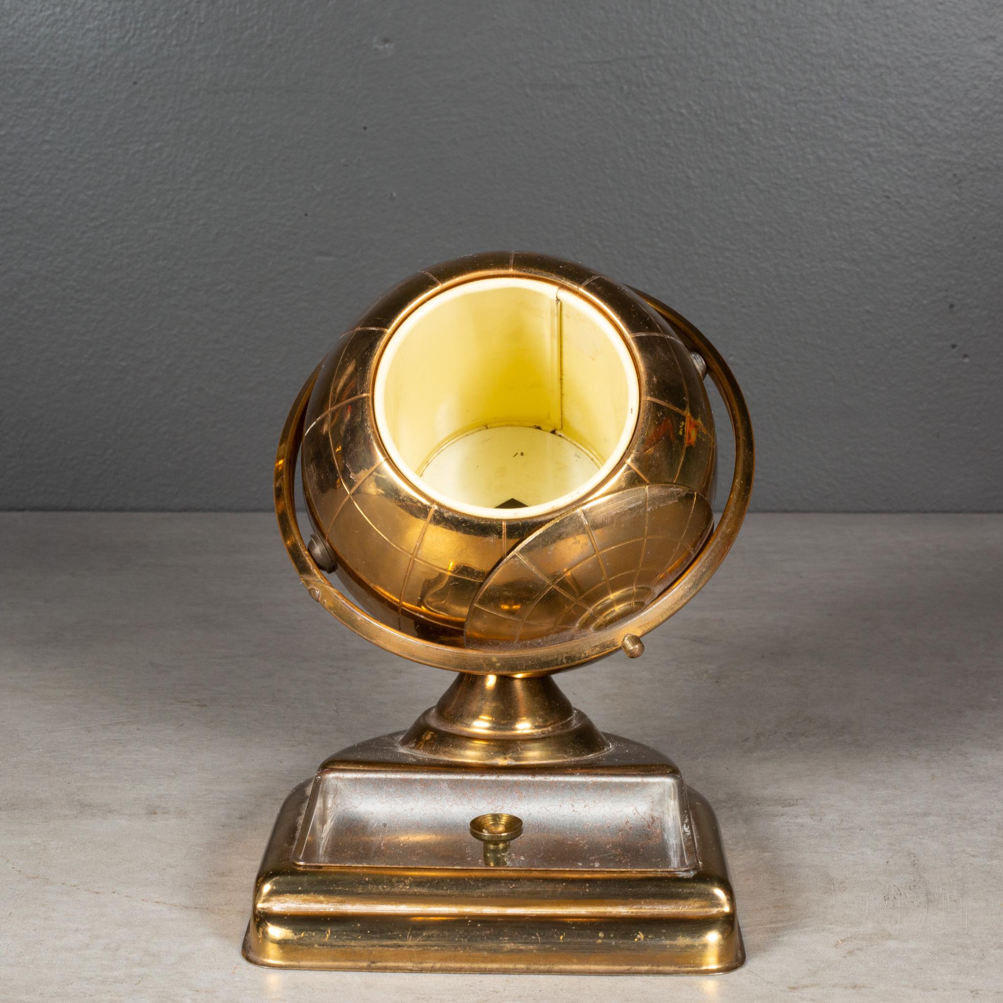 ABOUT

An original midcentury brass cigarette holder and ashtray or coin dish. The lid slides open on the globe's axis to reveal a metal interior designed to hold cigarettes. This globe is unique because it has an attached tray.

 CREATOR: Unknown.
