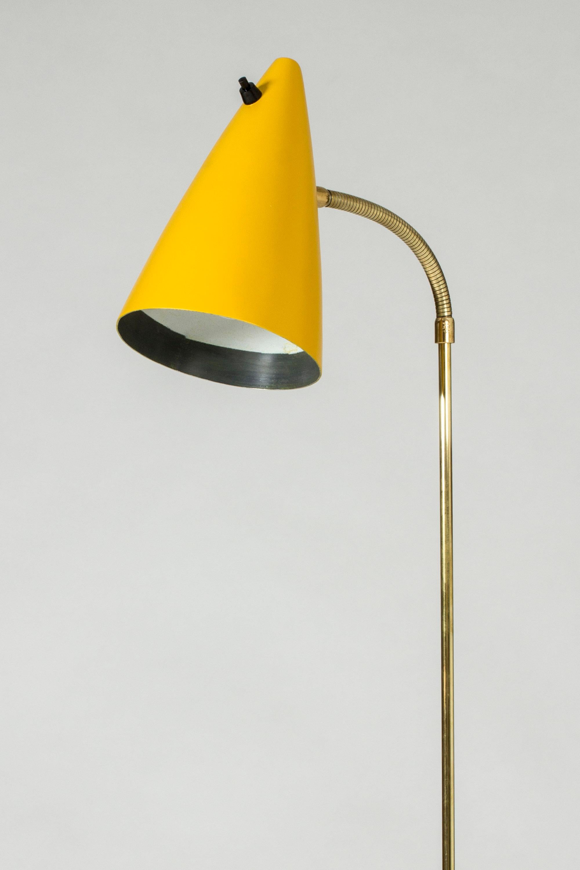 Cool floor lamp from Falkenbergs Belysning, with elegant brass details. Easy to move thanks to the little handle on the stem. Partially lacquered black, with a warm yellow shade.