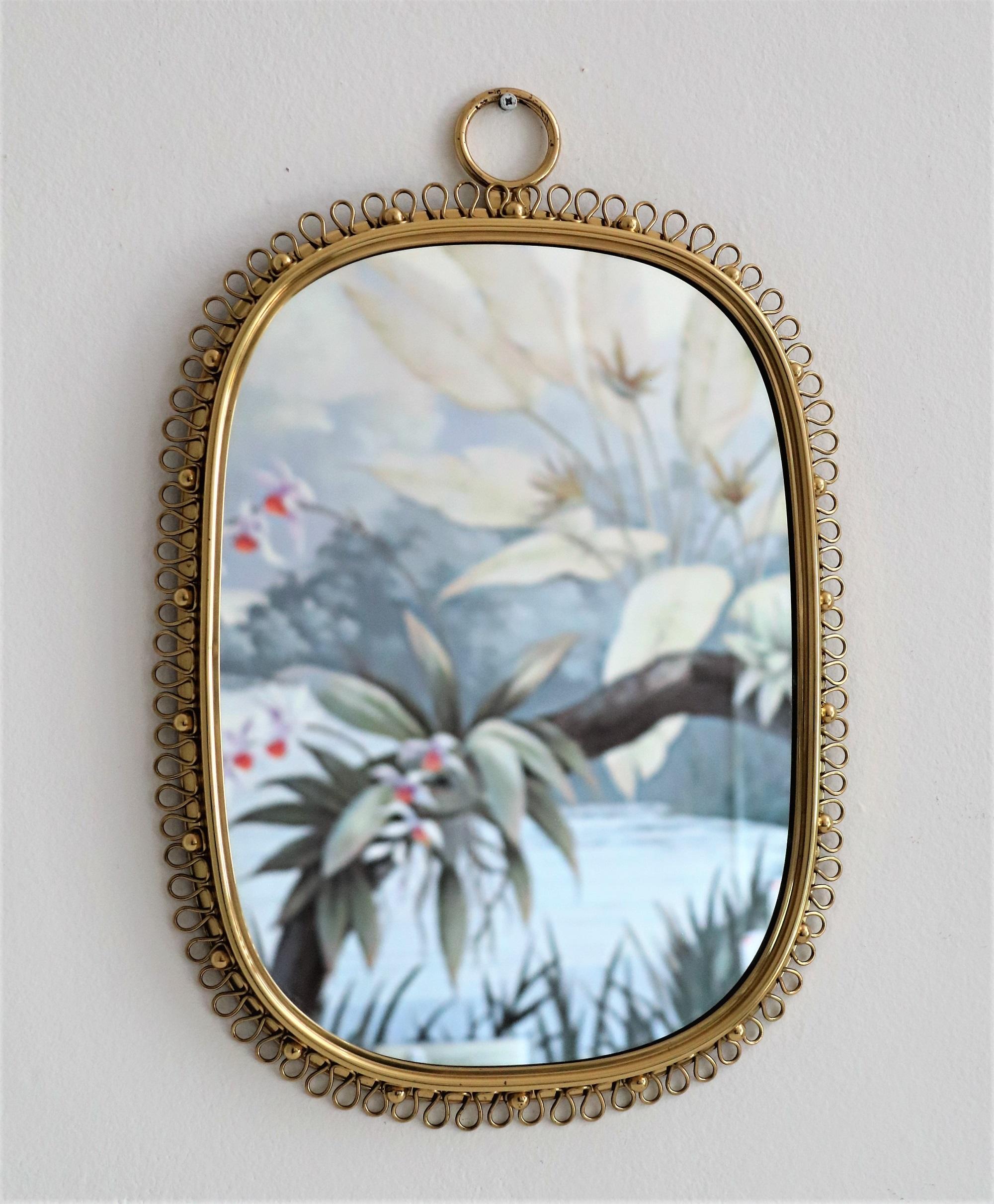 Gorgeous wall mirror designed by Austrian Josef Frank and manufactured in Sweden by Svensk Tenn in the midcentury.
This mirror is made of full shiny brass frame with spiral loop frame around and big round hanging loop on top.
You can easily