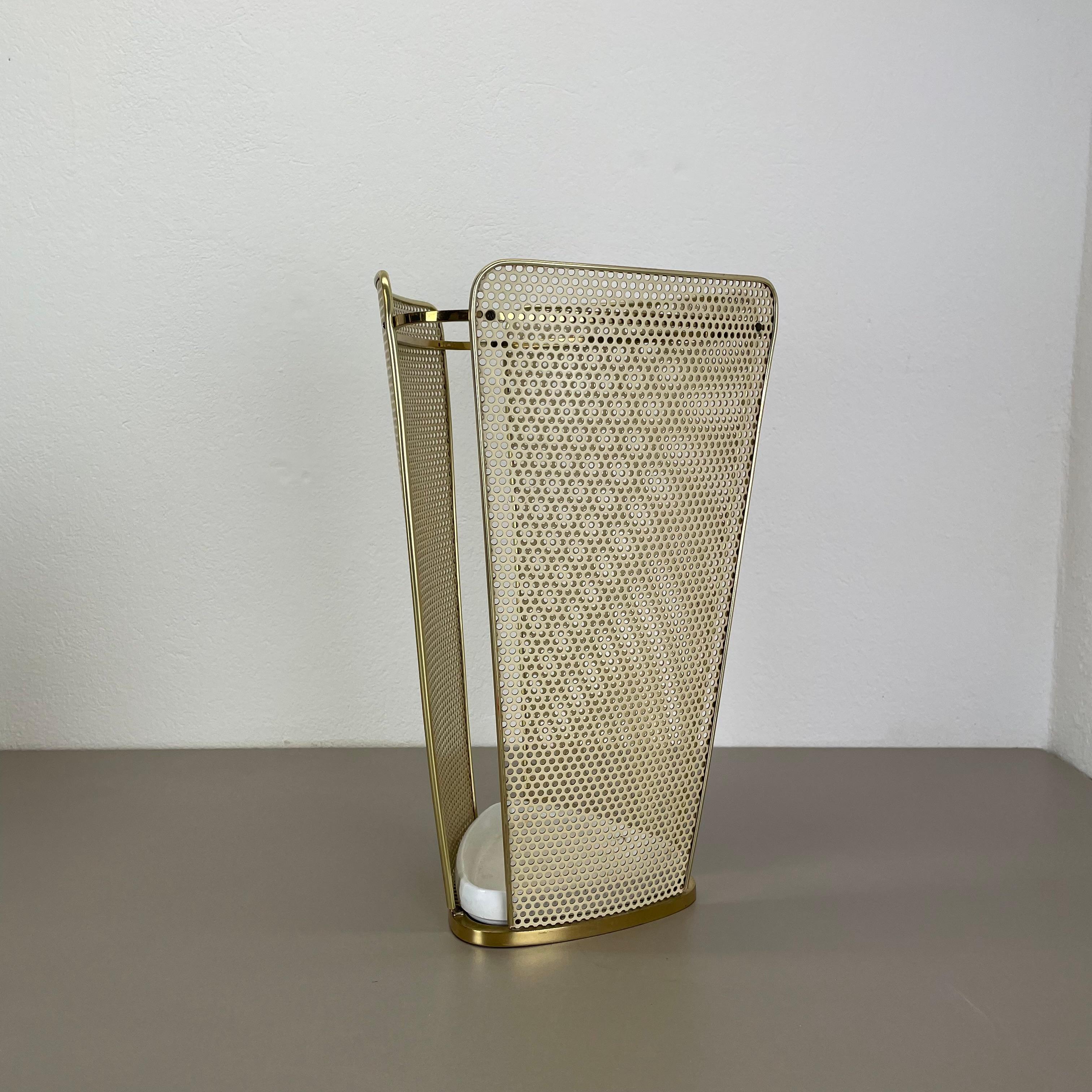 Article:

Umbrella stand in style of Matégot



Origin:

France


Age:

1950s



This original vintage umbrella stand element was produced in the 1950s in France. It is made of solid metal in a white lacquered tone with perforated hole pattern