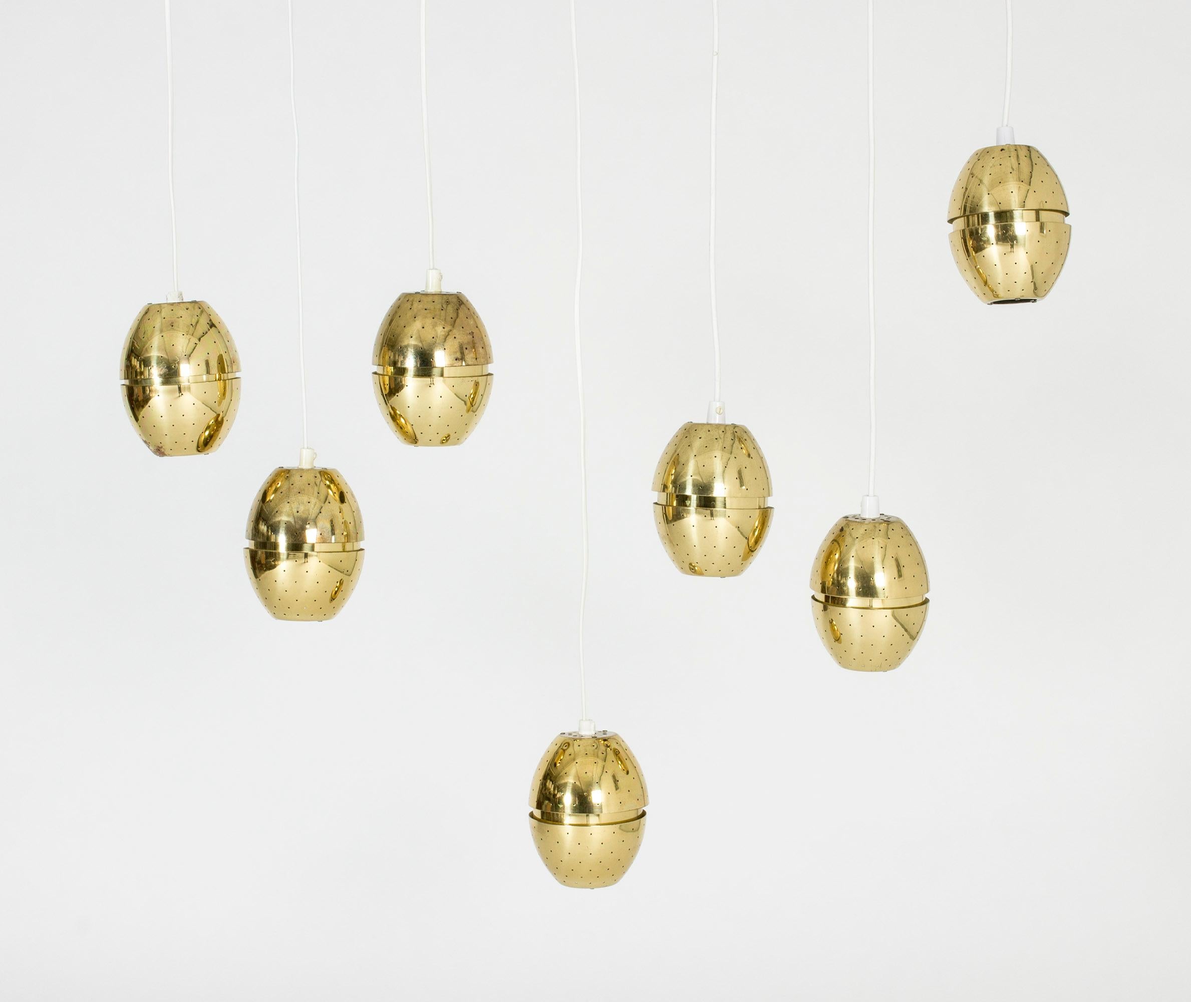 Cool, egg-shaped brass pendant light by Hans-Agne Jakobsson. Often used as a window light. Beautiful when lit with little points of light coming from every hole.