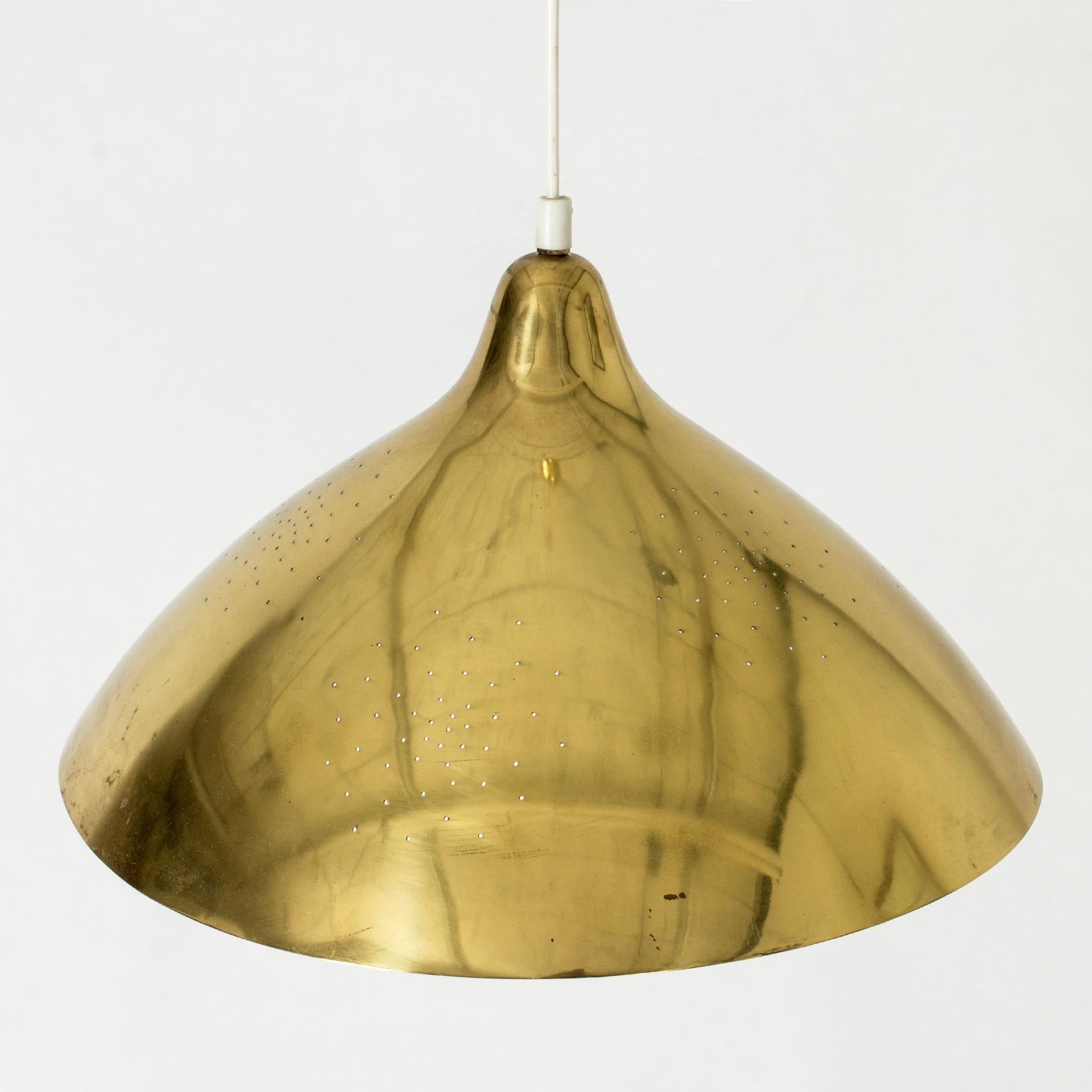 Sleek ceiling light by Lisa Johansson-Pape, made from brass. Voluminous form perforated with small holes that let the light out in a lovely way.