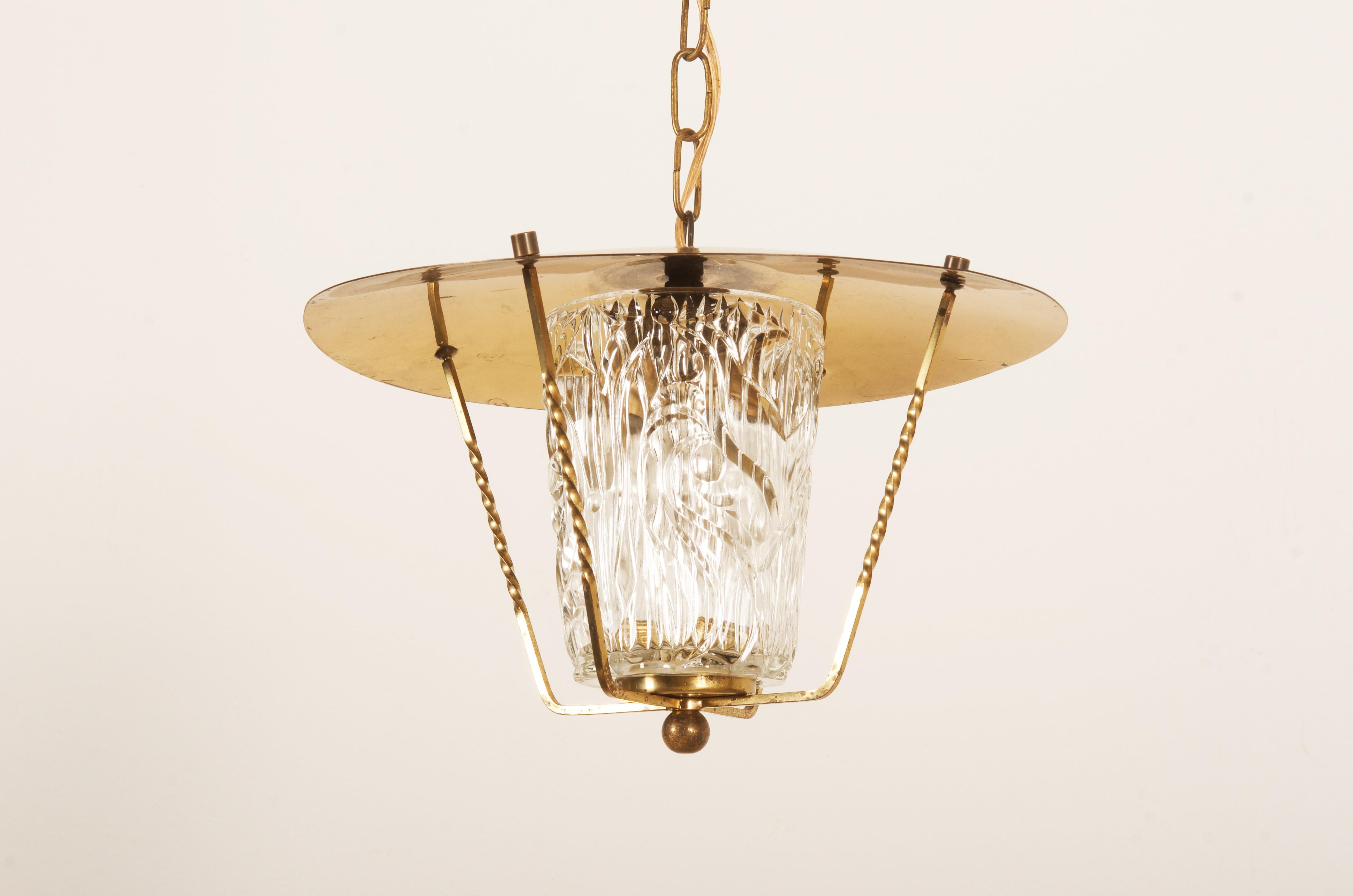 Brass frame fitted with one E27 socket and structured glass shade, made by J.T. Kalmar in the early 1950s.
