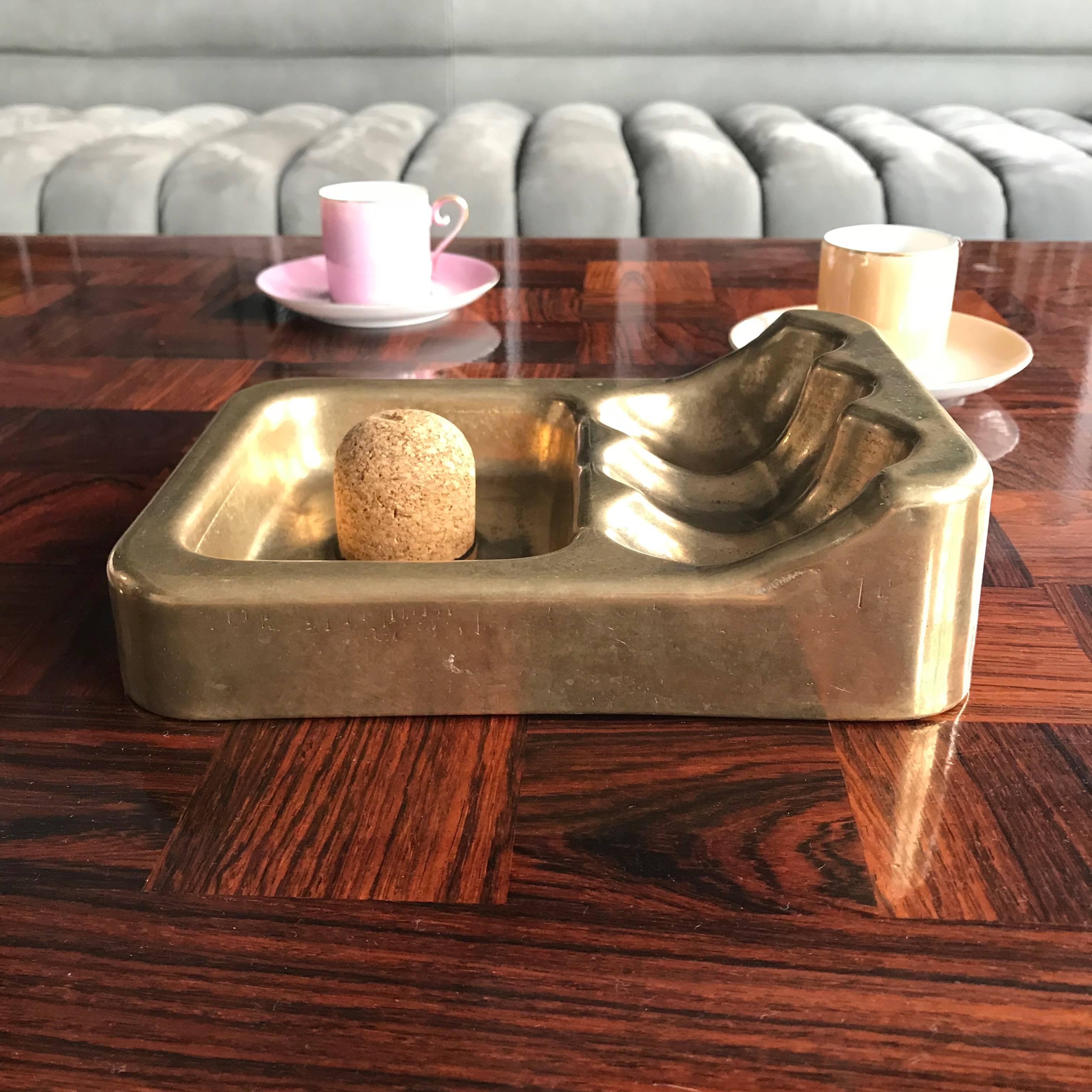 Huge brass pipe holder with ashtray from 1950s in style of Carl Aubock. Stamped with H and AUT.

Measures: 
L: 19.5 x D: 14.5 x H: 5.5 cm / L: 7.6 x D: 5.7 x H: 2.2.