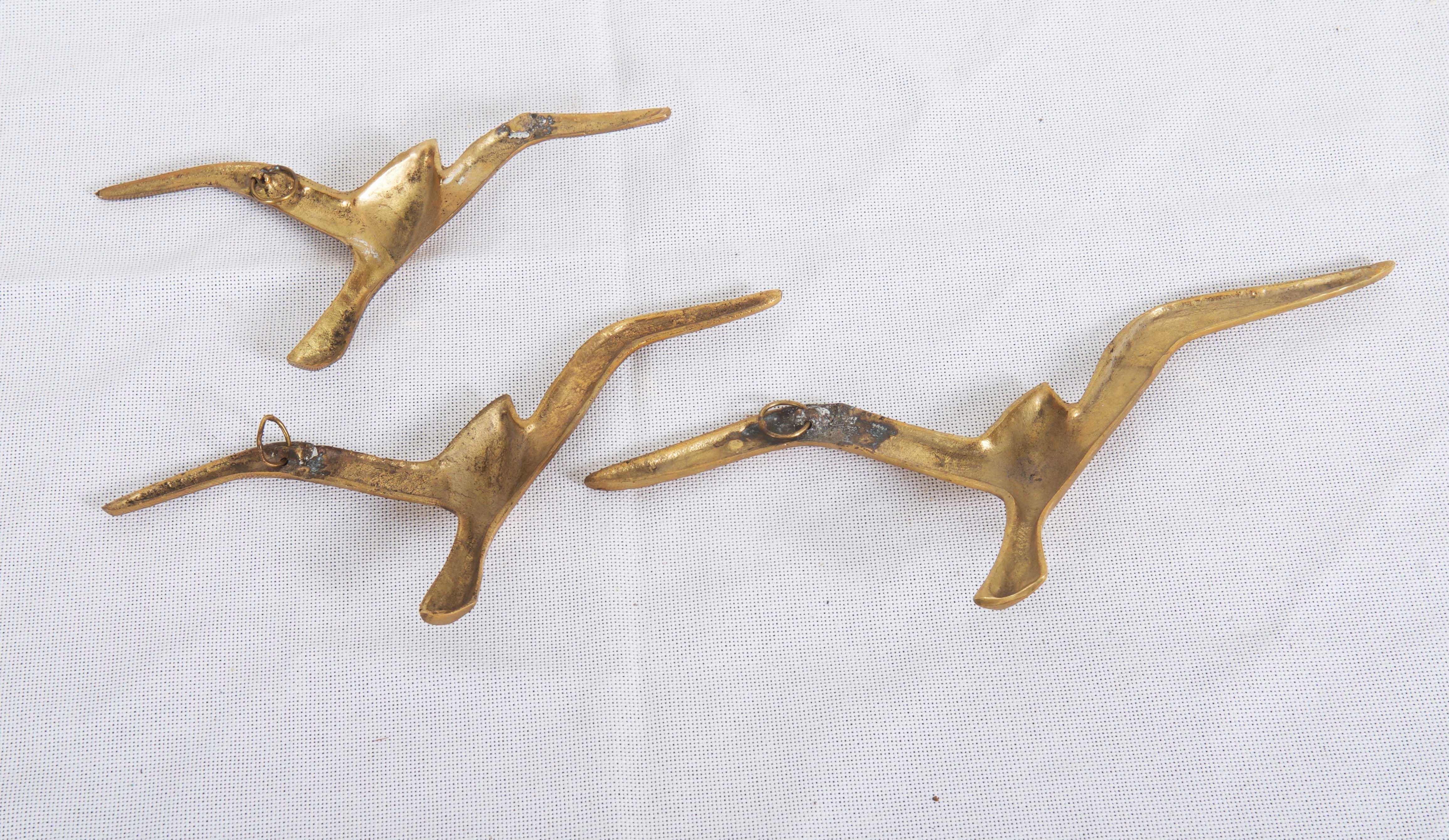 A set of three brass seagull wall mounted. Manufactured in Vienna in the late 1950s. In a good original condition.
Measures: Width of the birds 13 to 8 in.
 