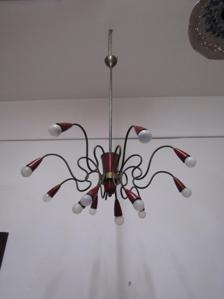 Sputnik model chandelier with brass structure made of painted aluminum parts. Twelve lights. In good condition.
