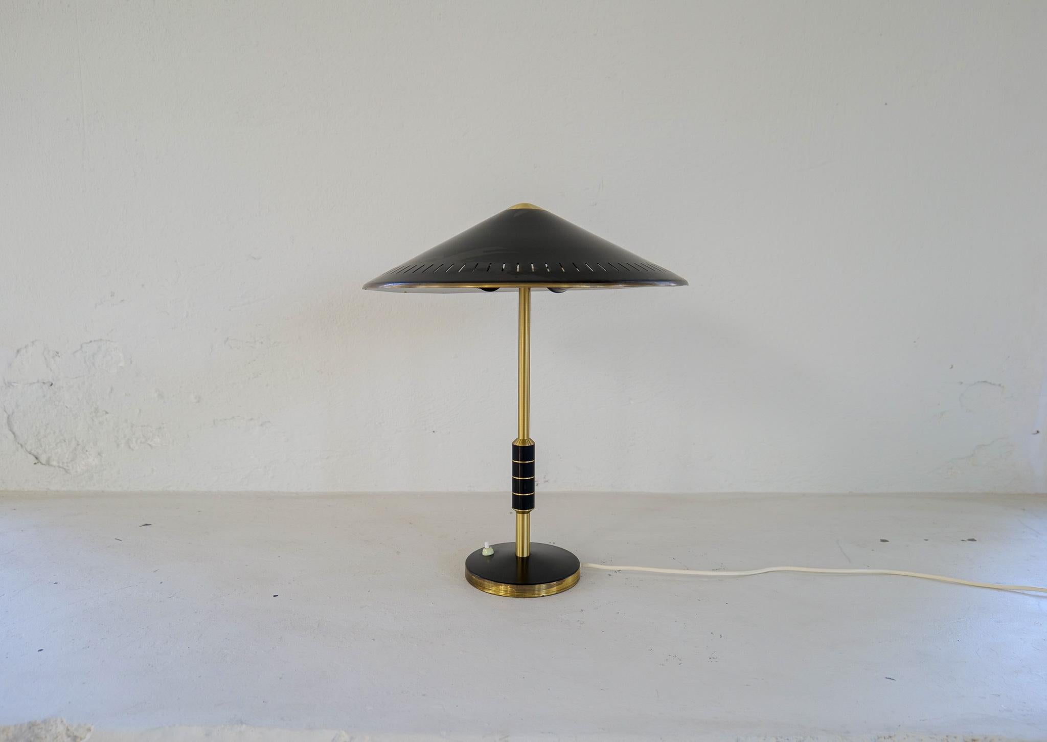 Midcentury Danish brass table lamp from Lyfa and designed by Bent Karlby 1956 Denmark. 
This somewhat rare black mode B146 with solid brass with two-light sources, stem decorated with black metal banding.

Good vintage condition, with wear and